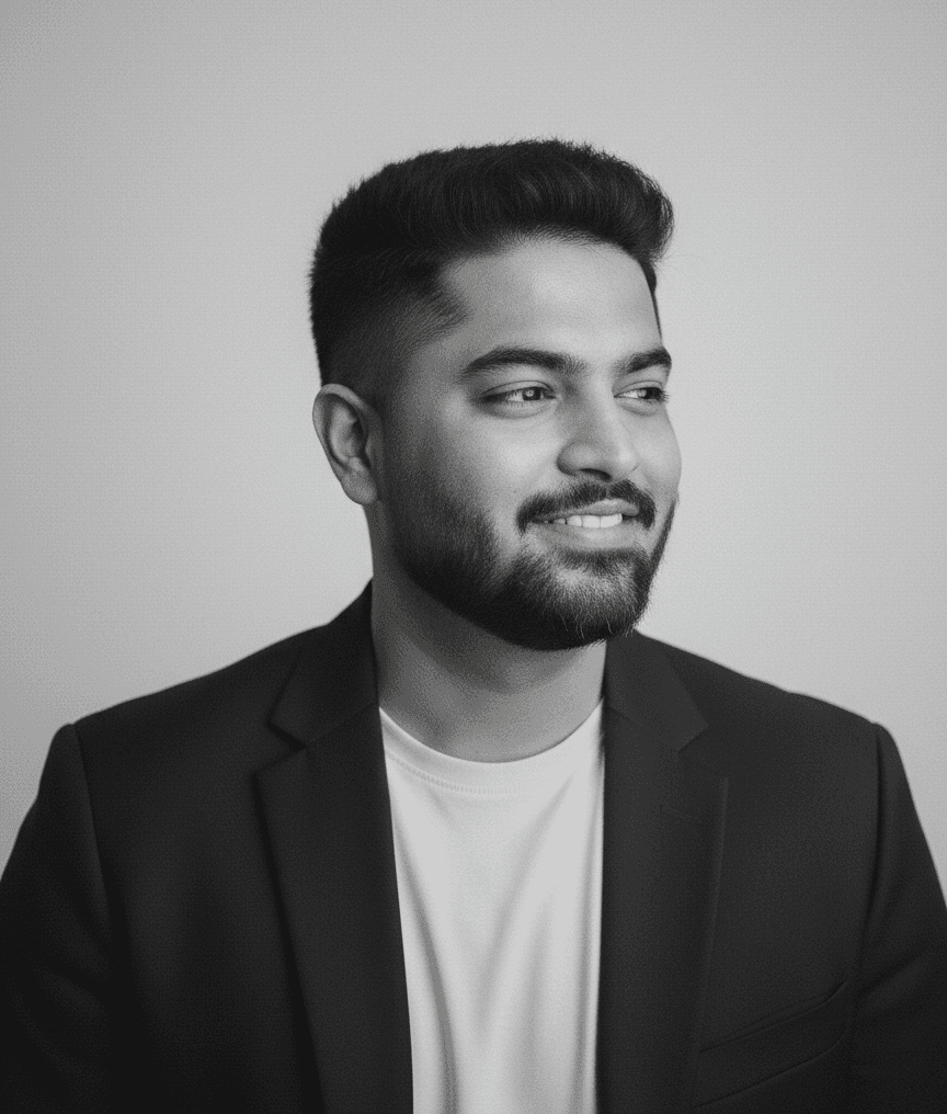Portrait of a woman with long, smooth hair swept to the side, in a dark t-shirt, on a plain background.
