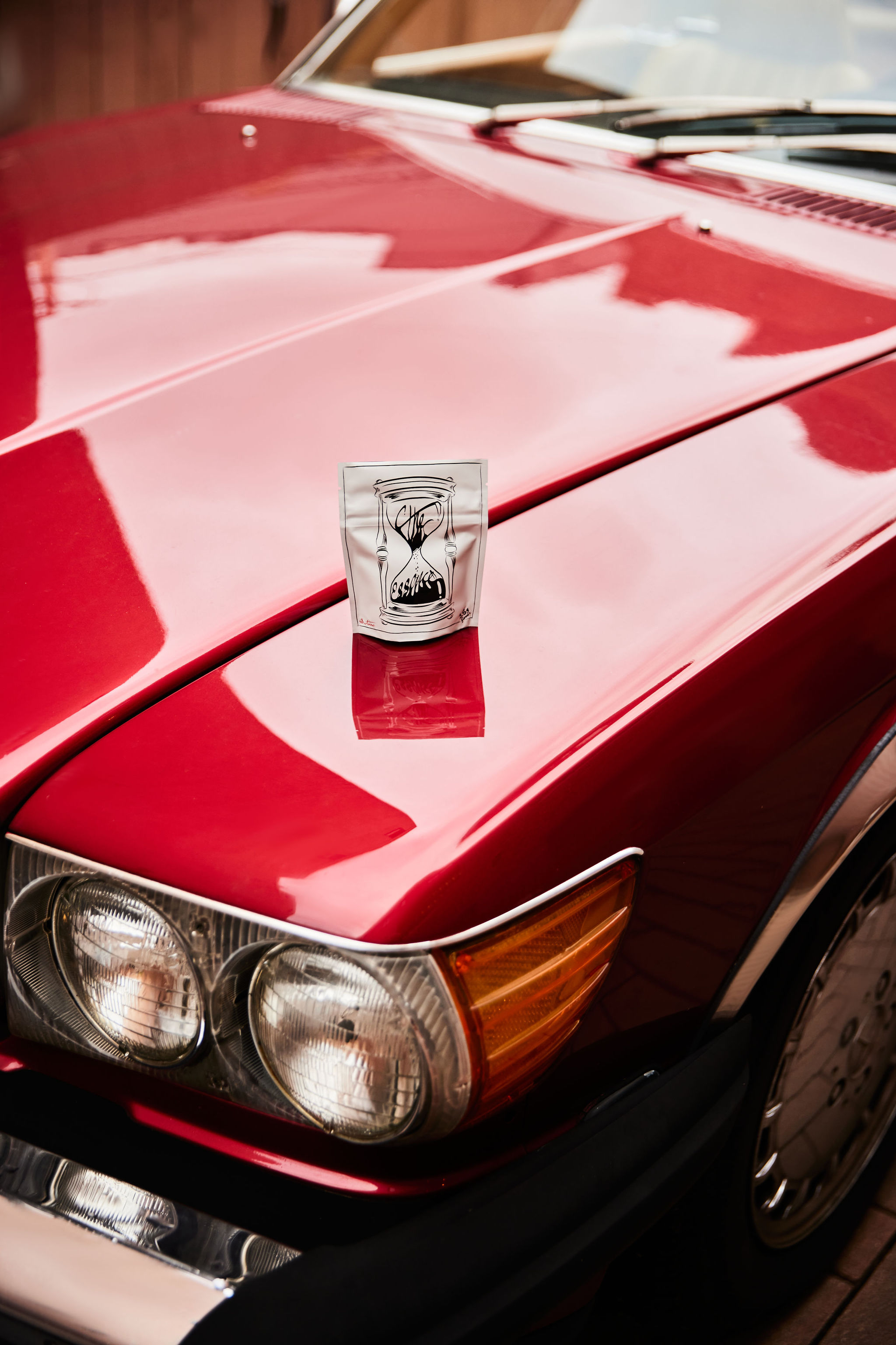 A tan sighthound stands in a grassy field.