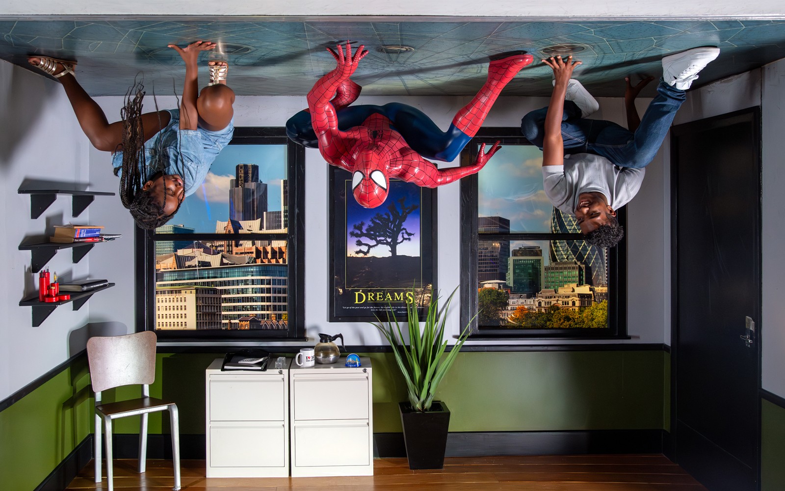 Spiderman wax figure at Madame Tussauds London with tourists taking photos.