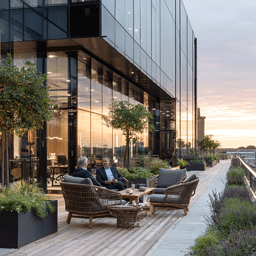 a white house with a green lawn and stairs