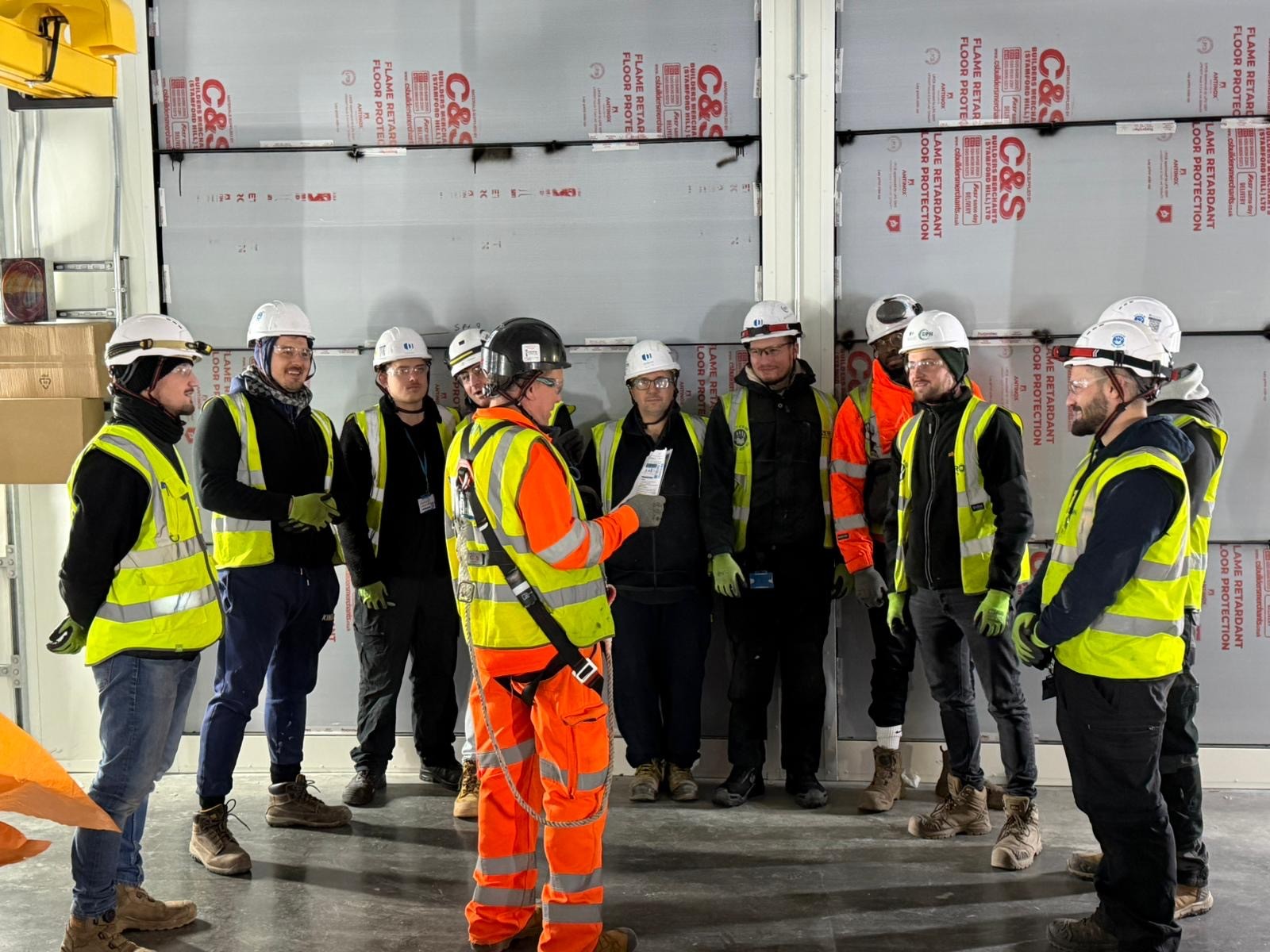 Modern glass skyscrapers reflecting a vibrant sunset with a mirrored plaza