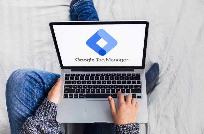 A laptop computer sitting on top of a wooden table