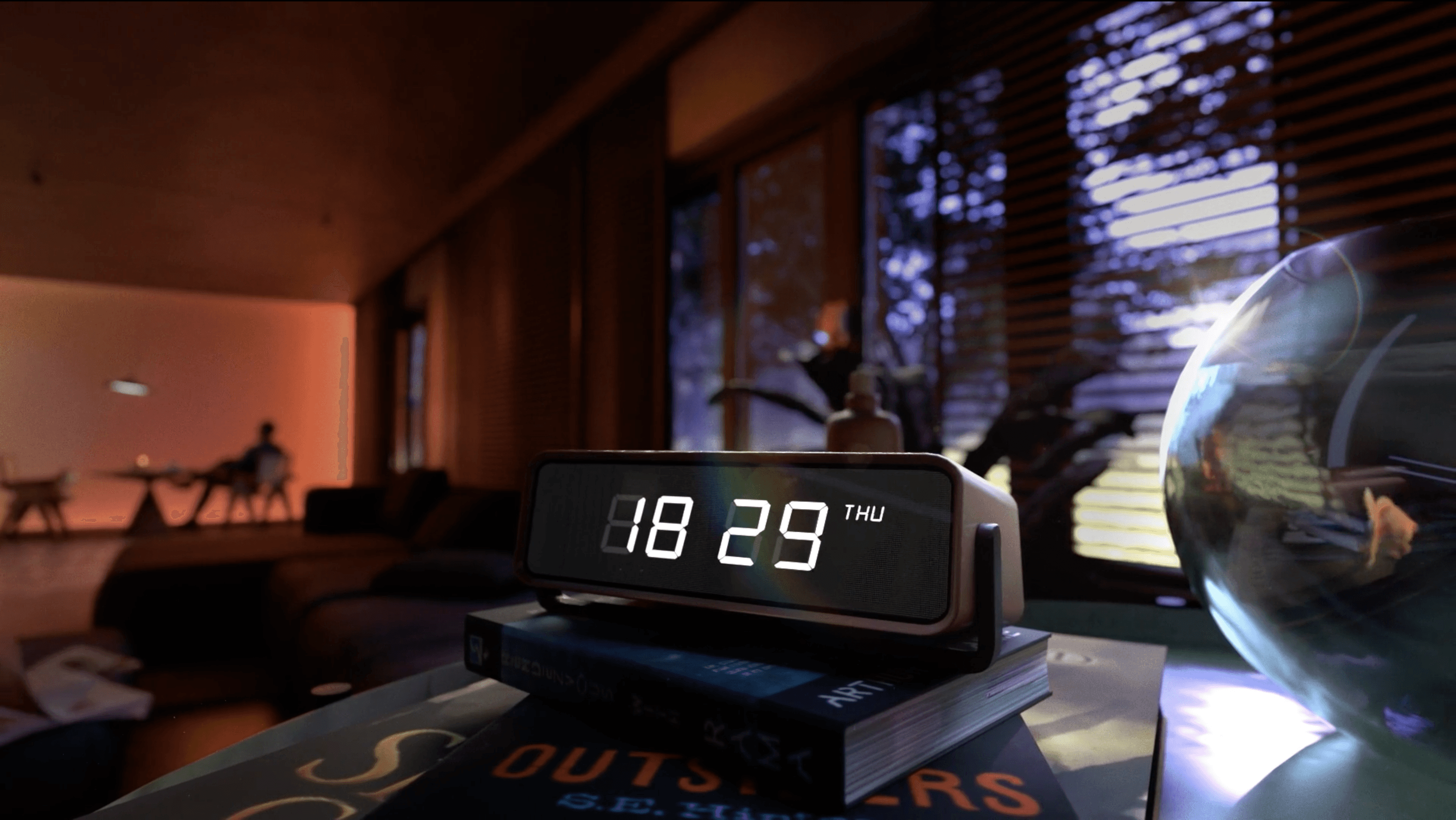 A close-up of a hand wearing multiple decorative rings against a blue background.