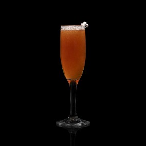 A closeup of a NEFT New Year drink against a dark background.