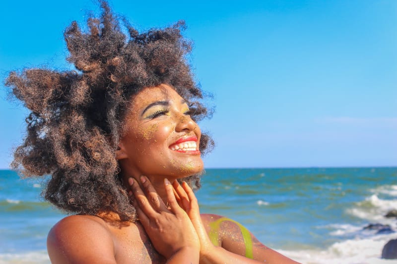 woman on beach smiling with happy energy