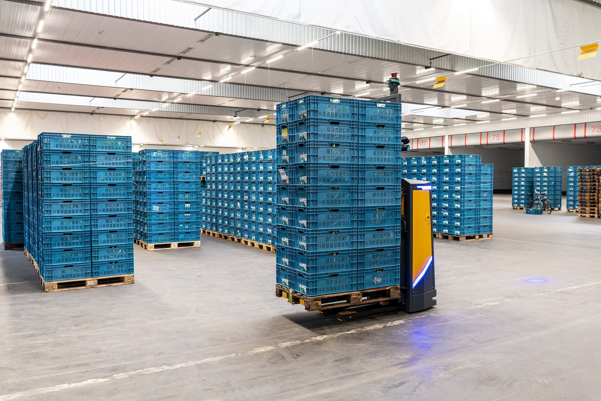 Automated guided vehicles (AGVs) moving pallets in a warehouse, showcasing automation in material handling