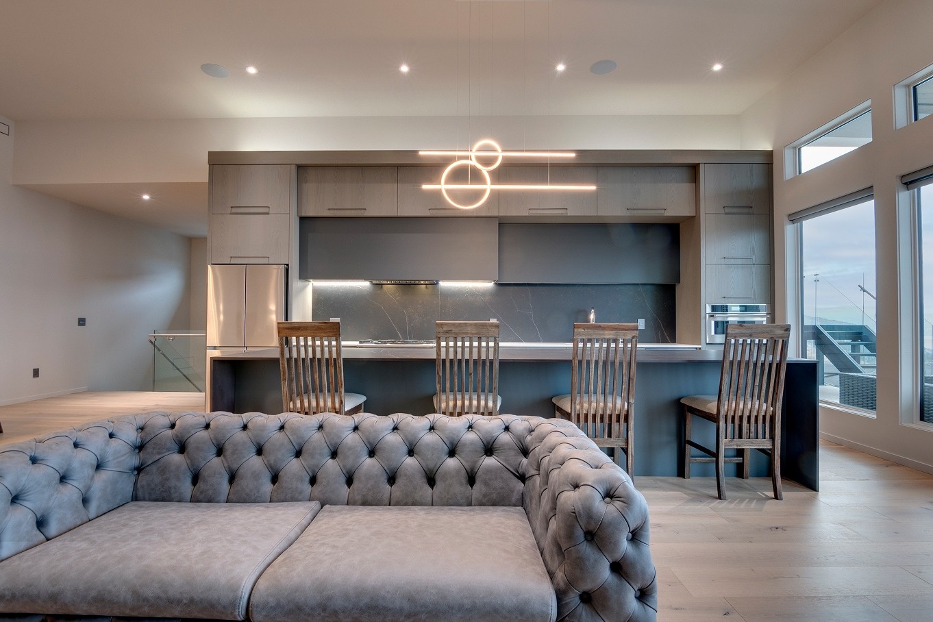 Kitchen and living room with custom cabinetry and furniture