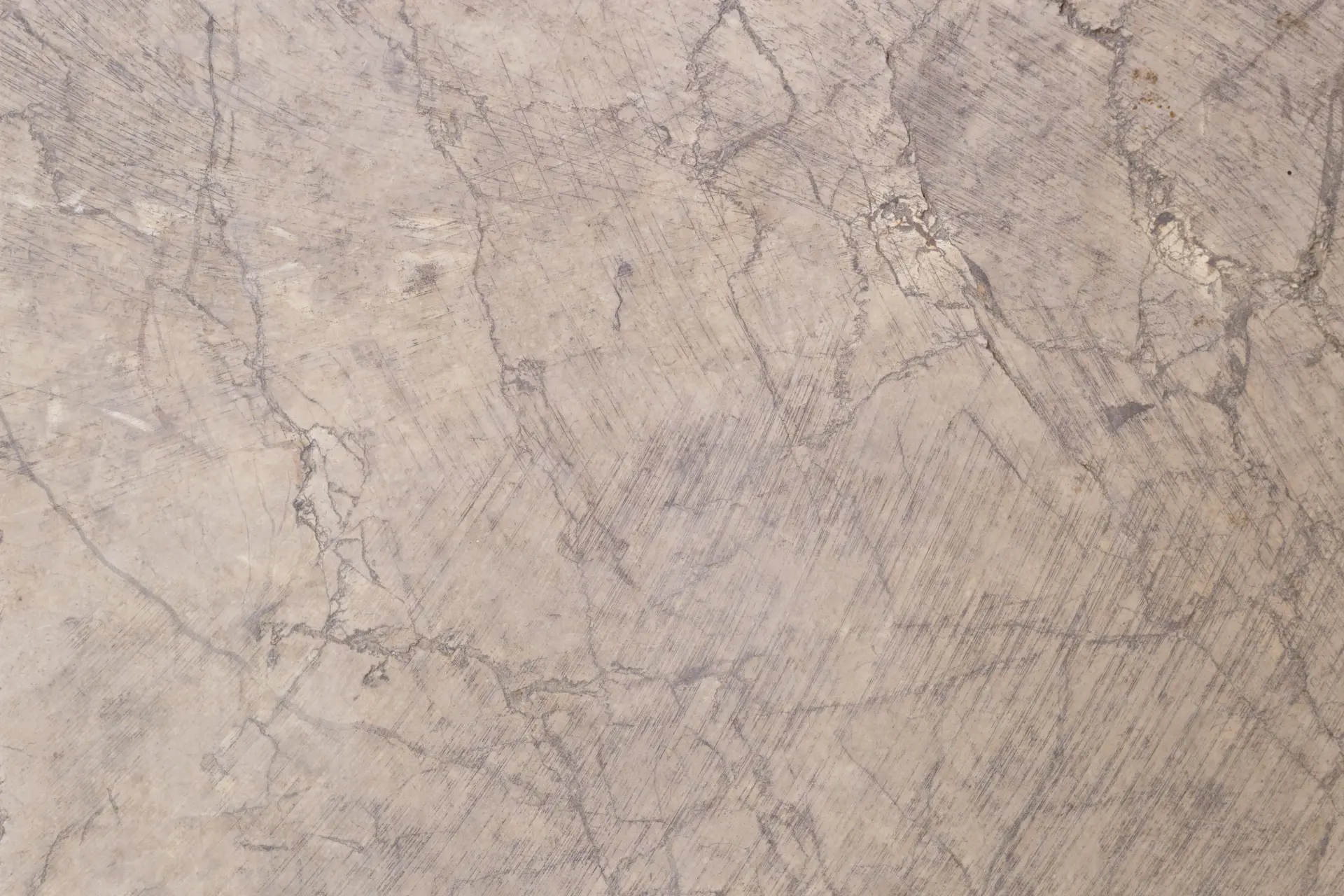 A slab of warm and elegant Botticino marble from Italy with a soft beige background.
