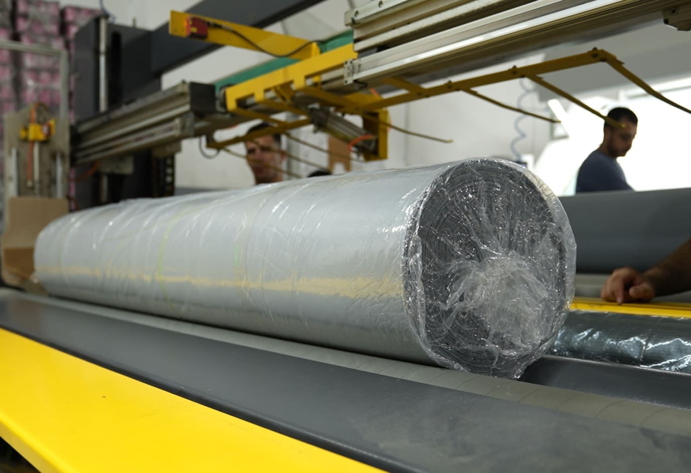 Fabric roll on conveyor.