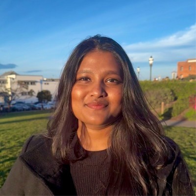 A young woman poses for a black and white photo.