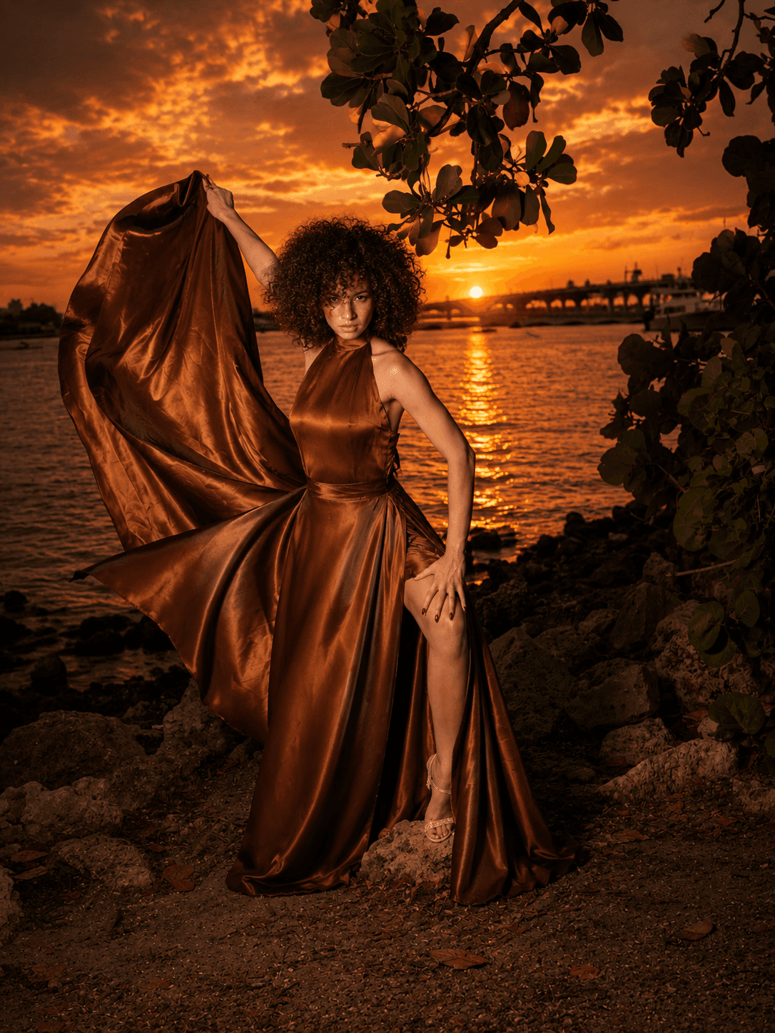 Leila Felix posing in a bronze editorial gown