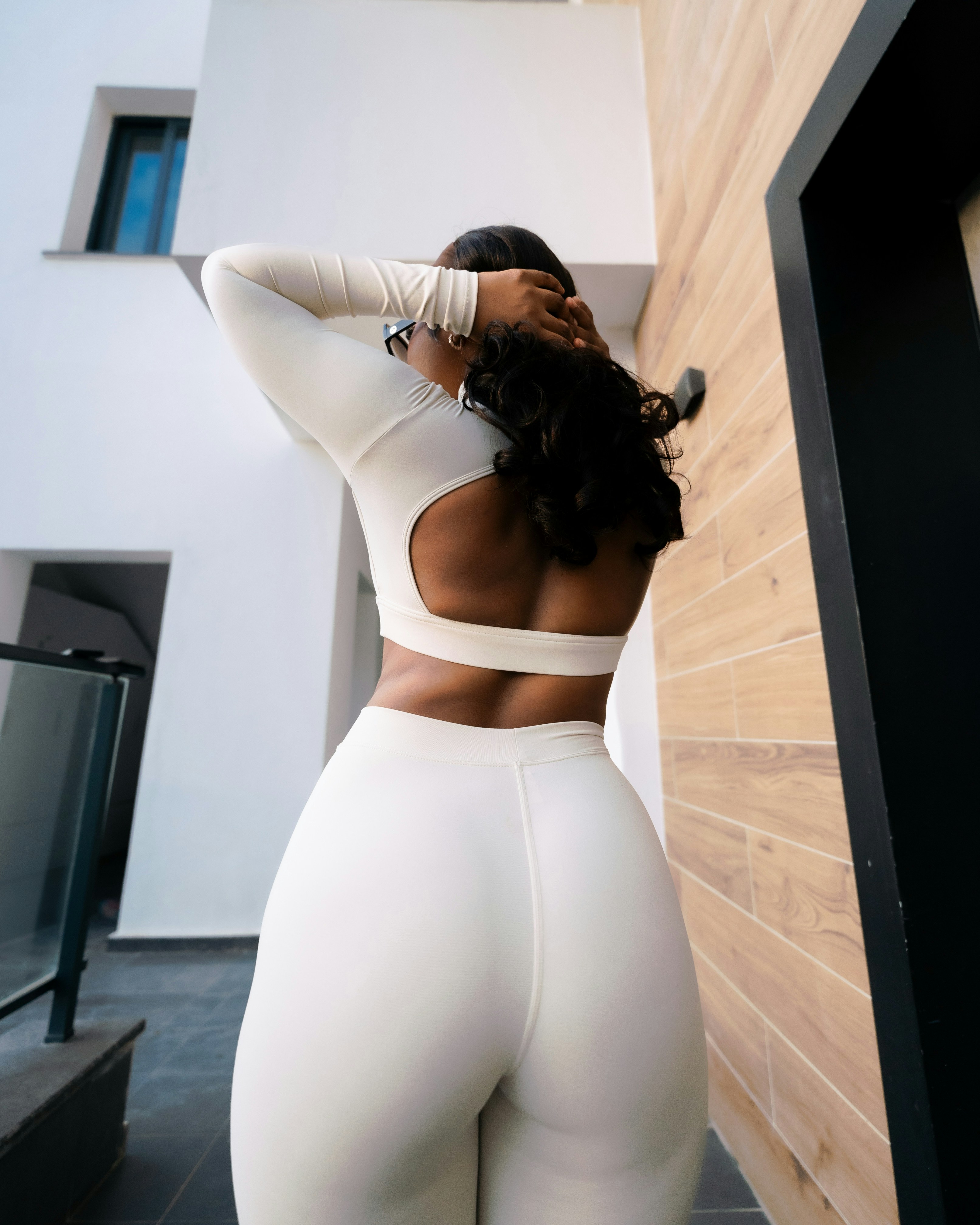 Woman in white athletic wear posing outdoors