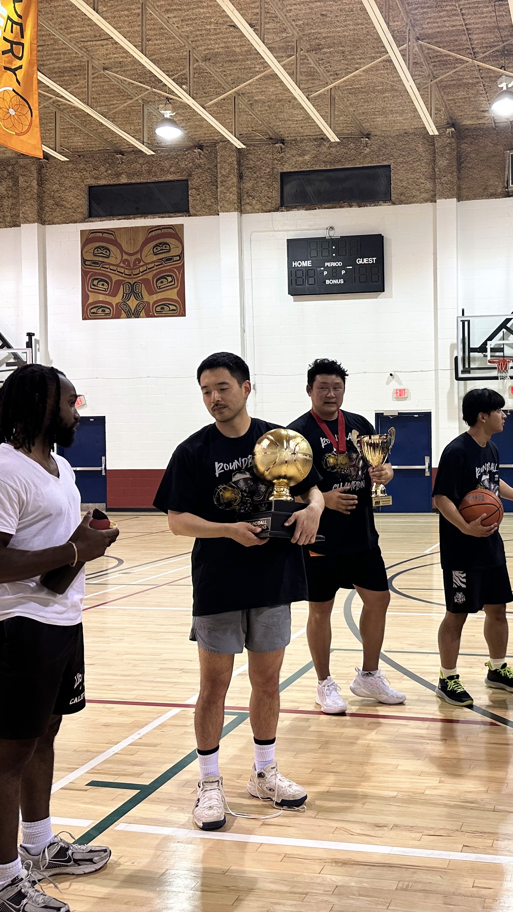 A green butterfly rests on a flower.