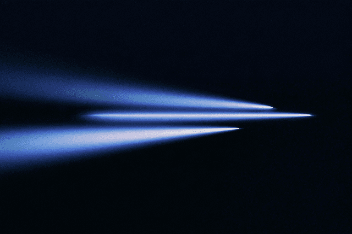 Three blue light trails travel across a dark background.