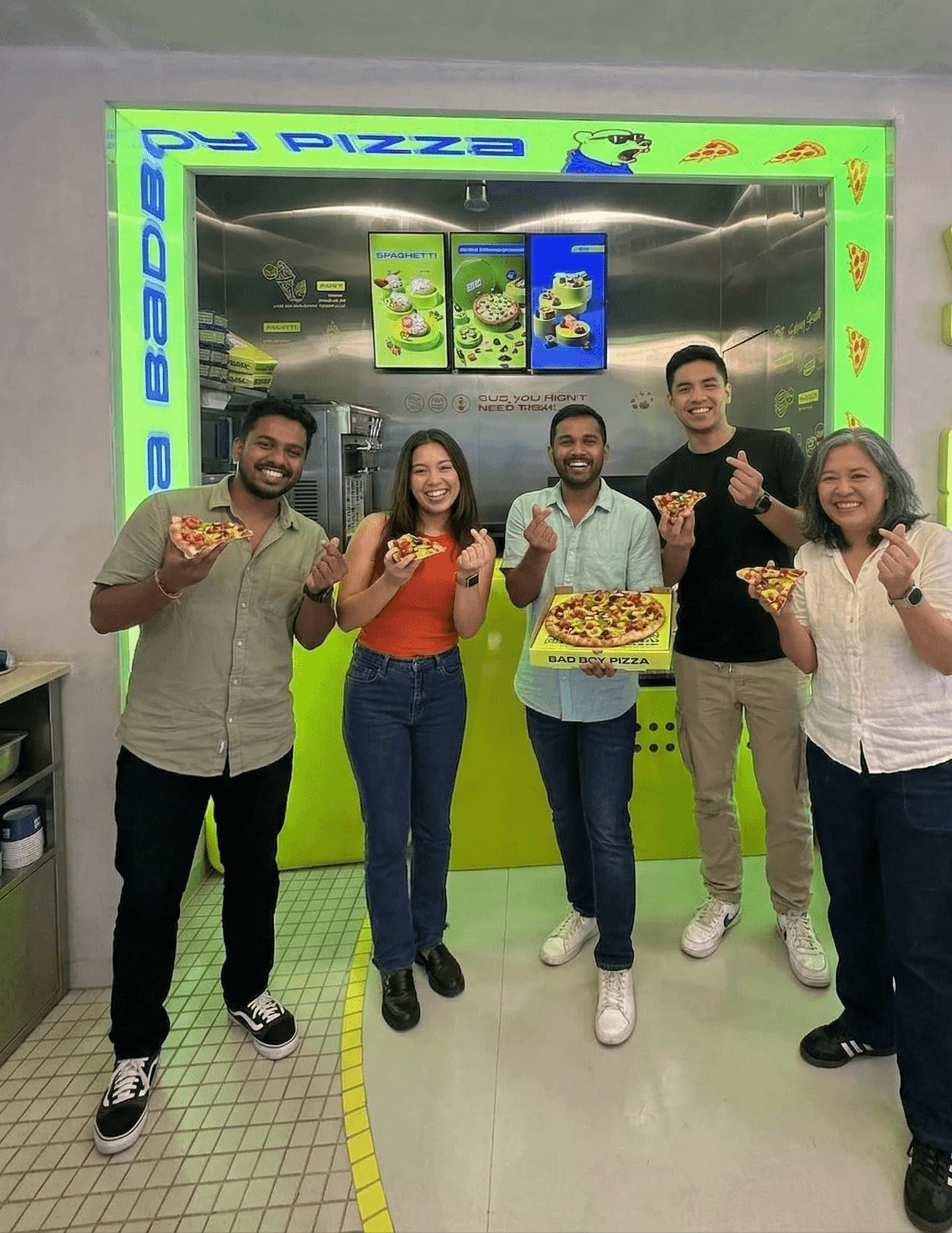 Aerial view of a winding road surrounded by dense green and yellow trees, showcasing nature’s vibrant colors.