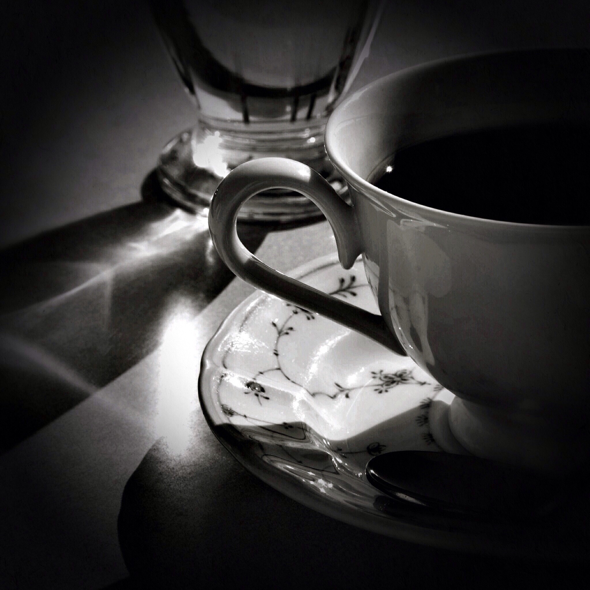 Close-up of a coffee maker with a cup.