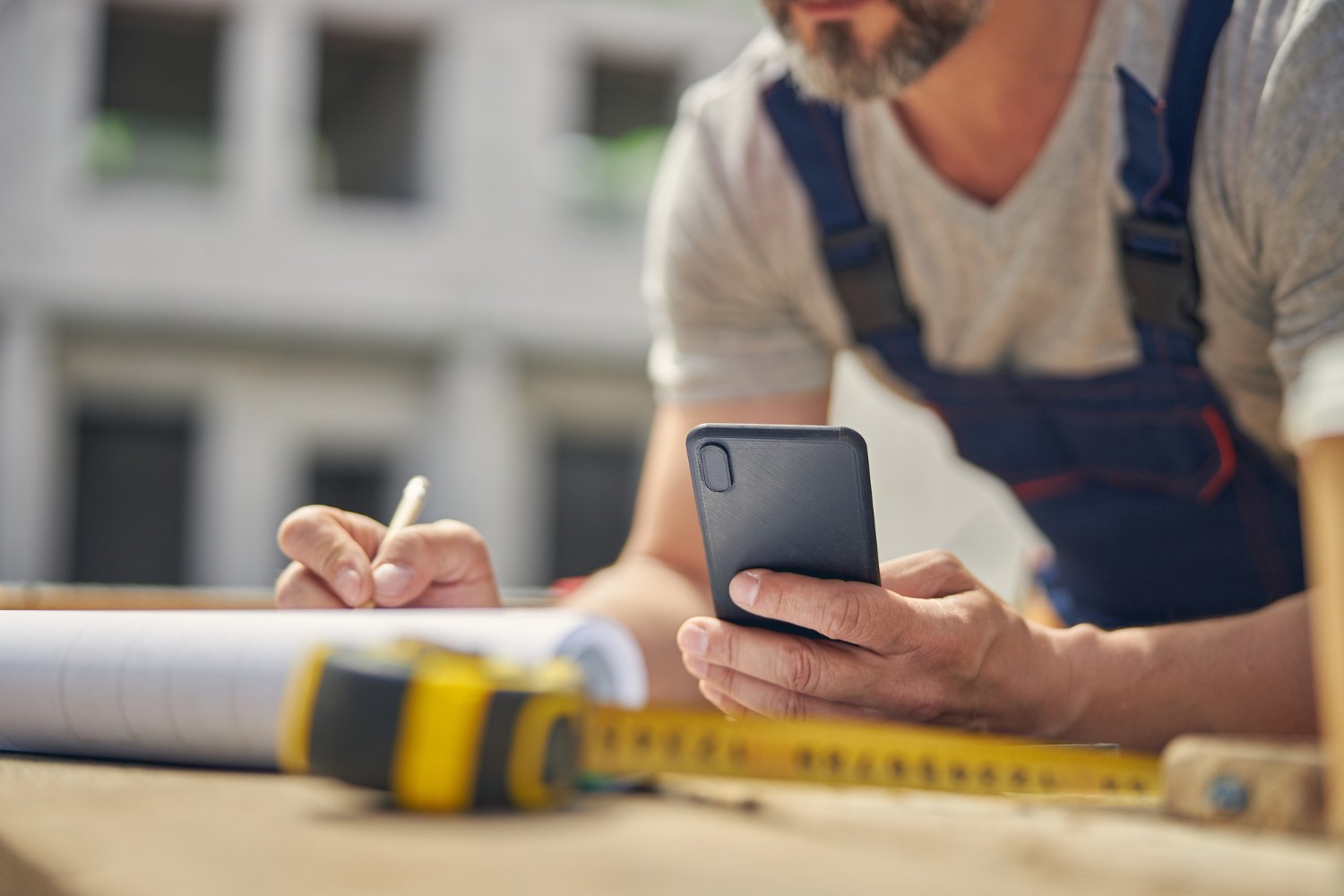 Professional working using some notes from the phone.