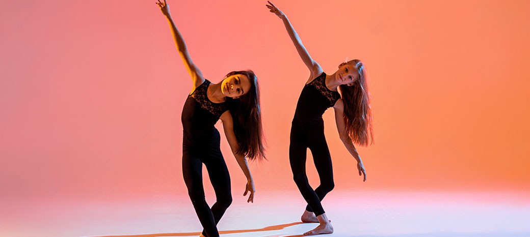 Students performing expressive contemporary dance choreography in after school performing arts program