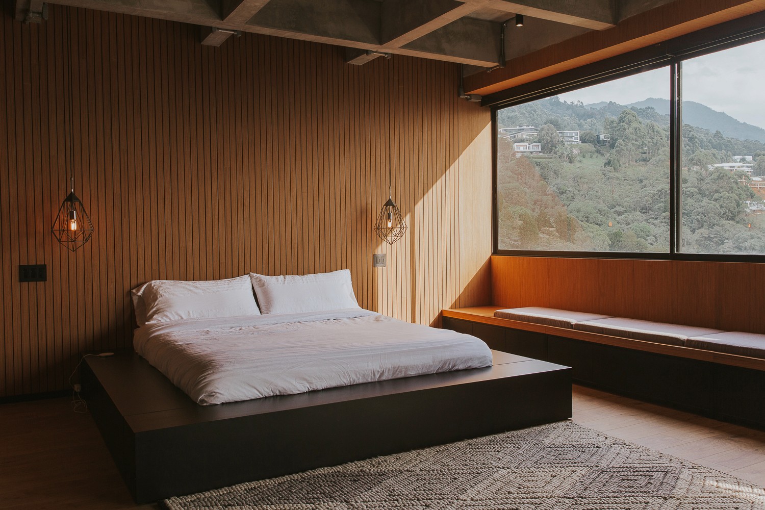 Double-height interior with flowing sculptural forms and warm raking light