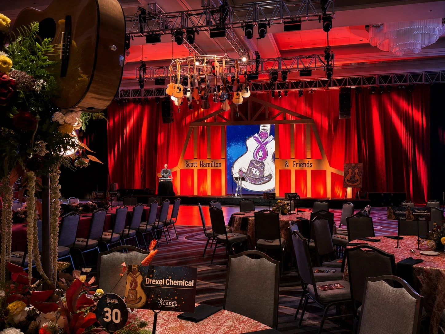 Barn-themed red stage and floral-topped dining tables at the Scott Hamilton CARES Opry Gala, Nashville — lifestyle event production by UpLight Technologies