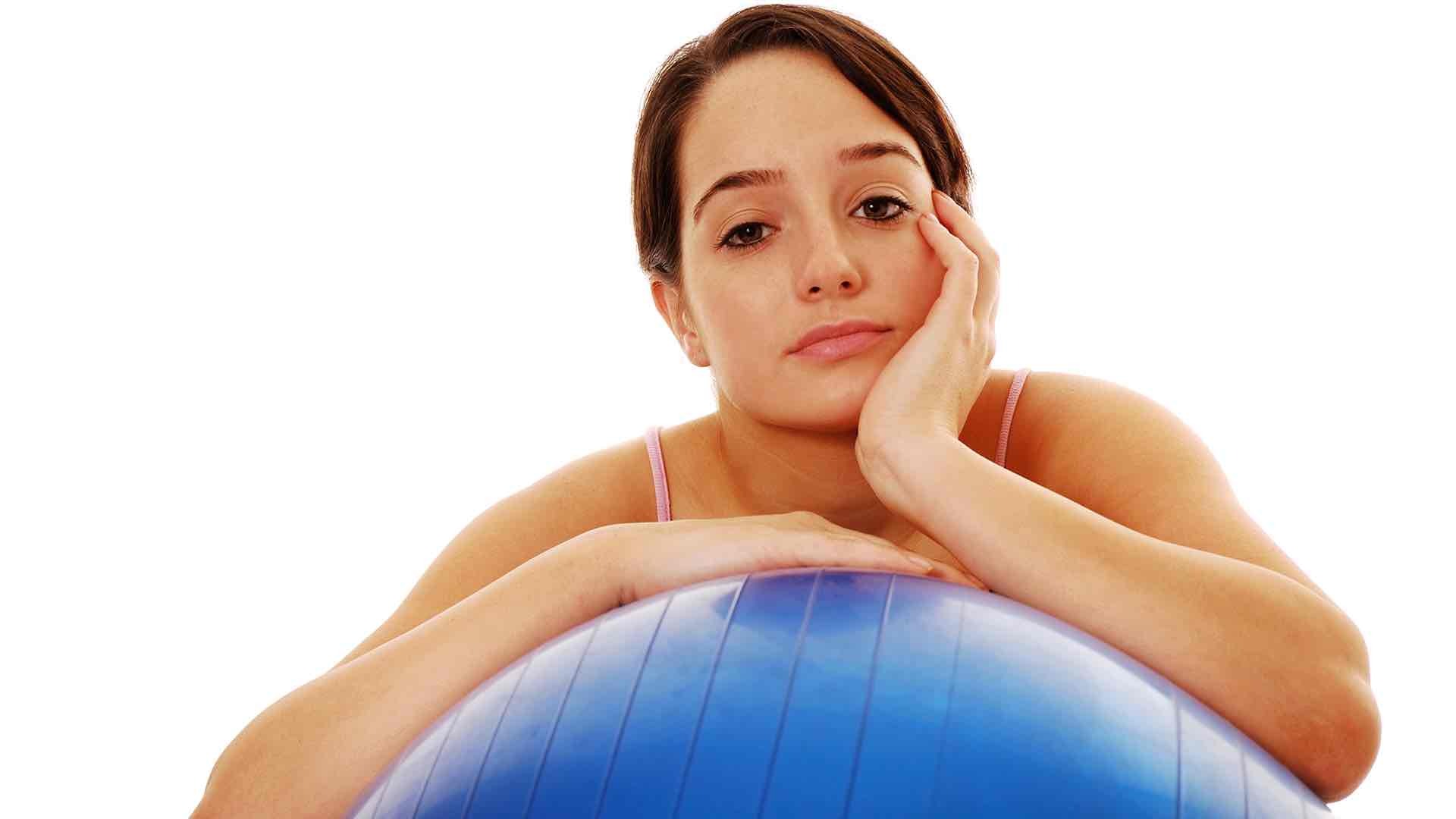 problematic woman leaning on a swiss ball