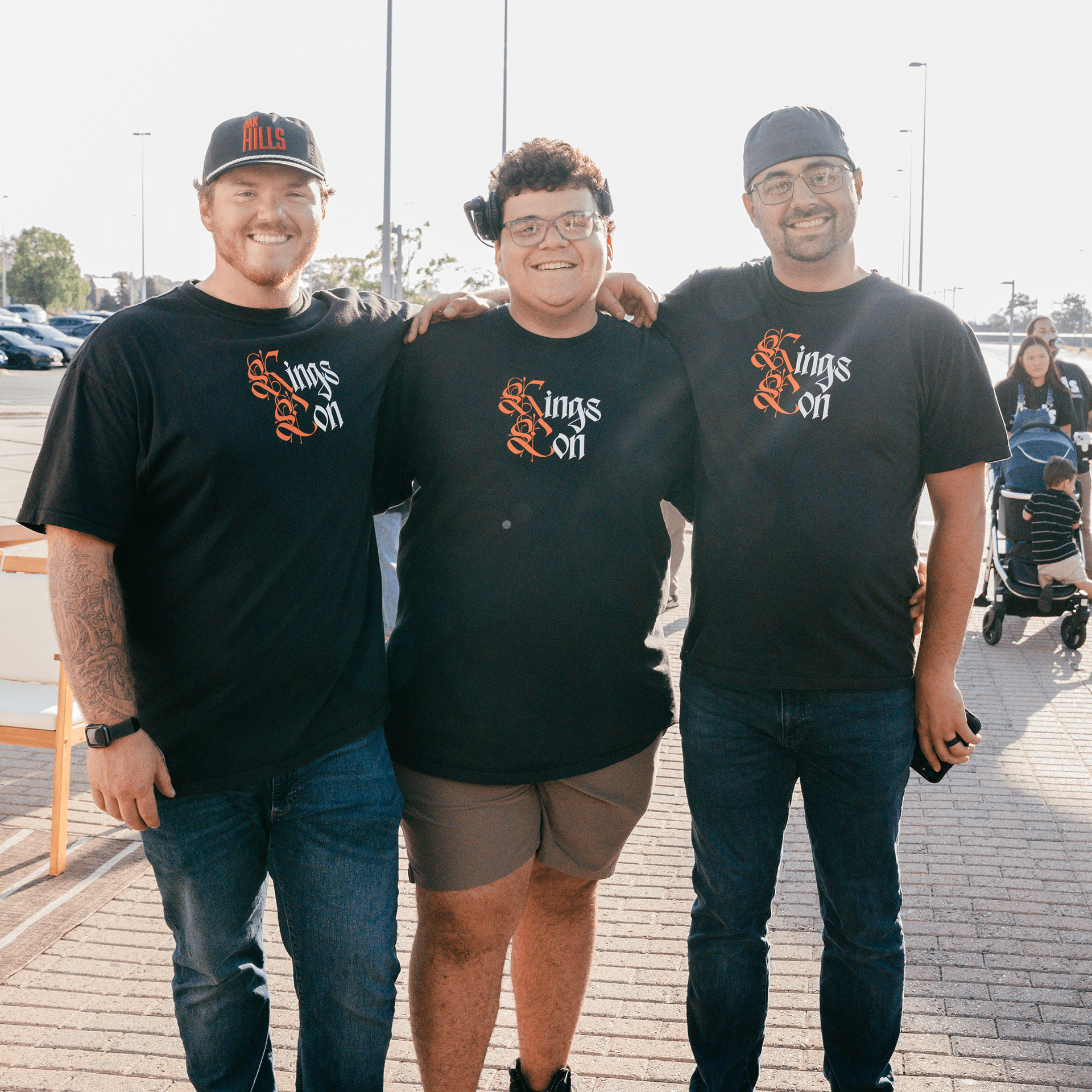 Three men smiling together.