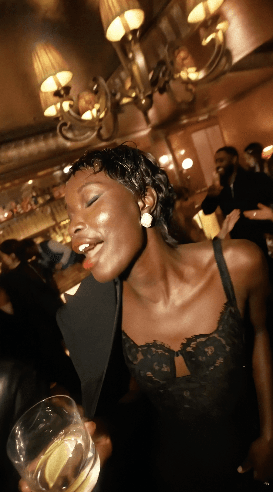 Woman in black outfit sitting on floor