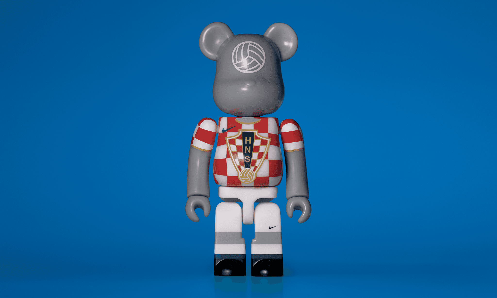 A single 3.5” tall Bre@rbrick/Nike toy created to commemorate the 2006 Croatian World Cup football team. The toy is painted to appear in the Croatian football kit and stands in the center of the frame in front of a bright yellow background.