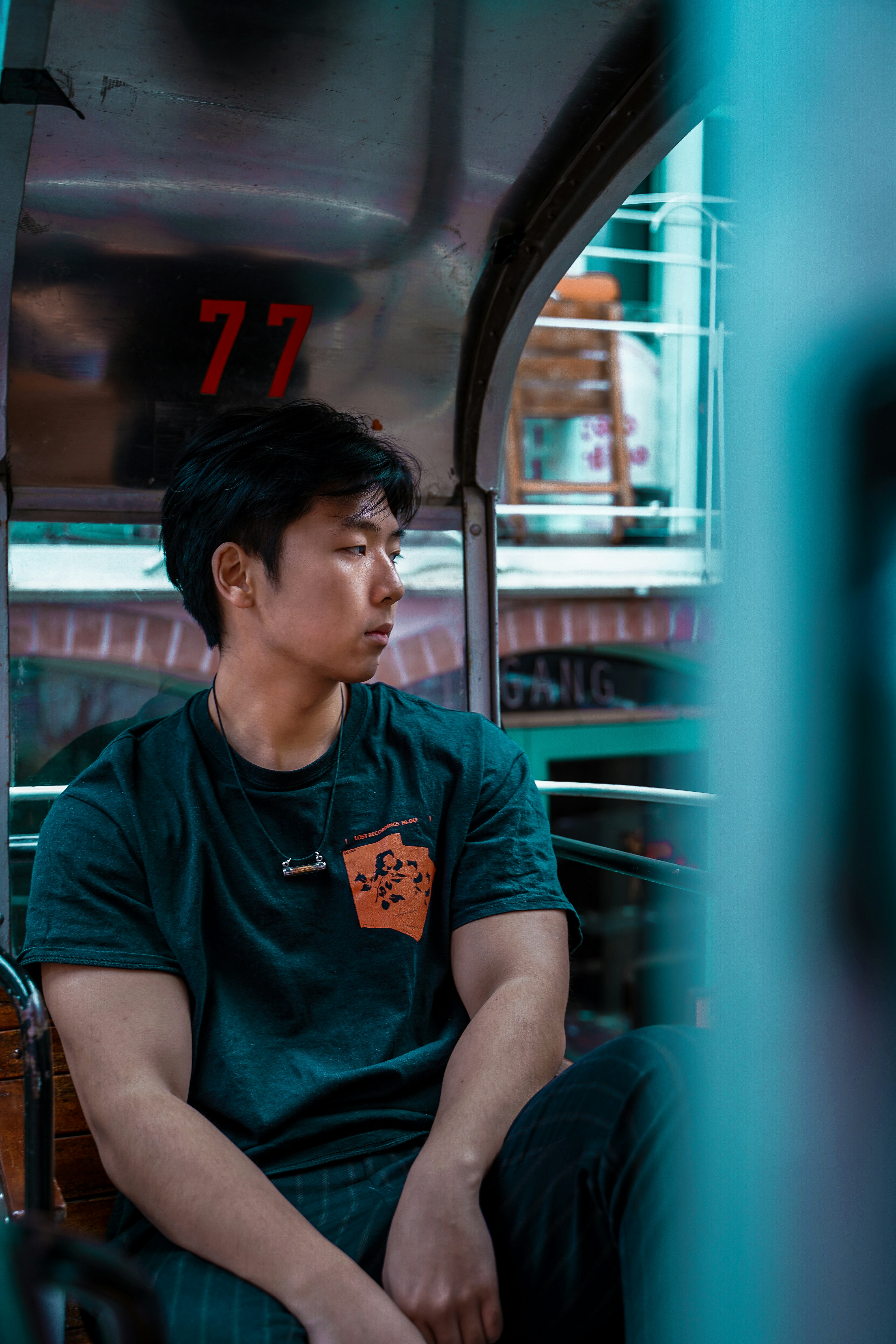 a man sitting on a bus looking out the window