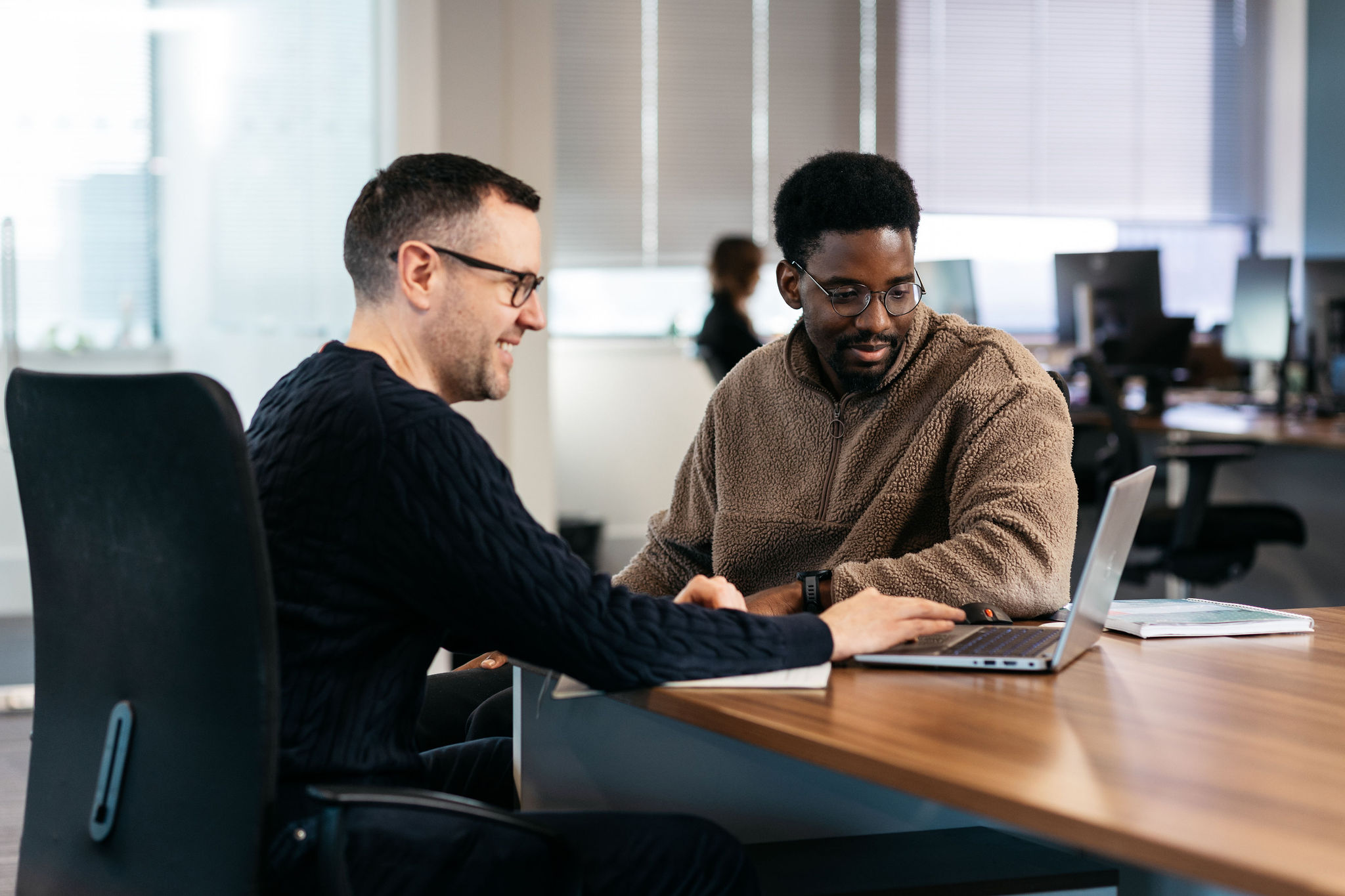 Planning session with two product speciallists working at a laptop