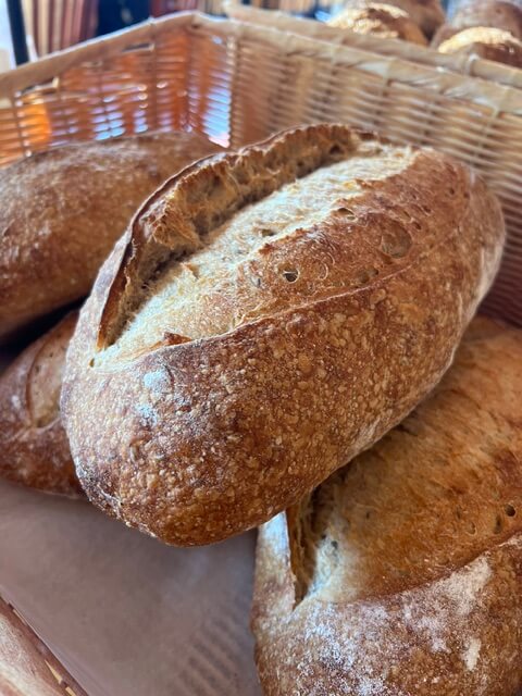 A round sourdough loaf in a basket.