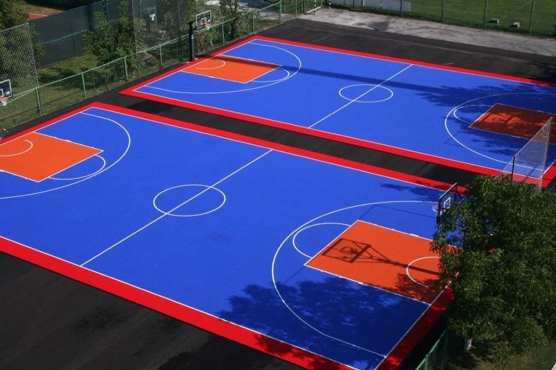 Aerial view of blue pickleball courts with players