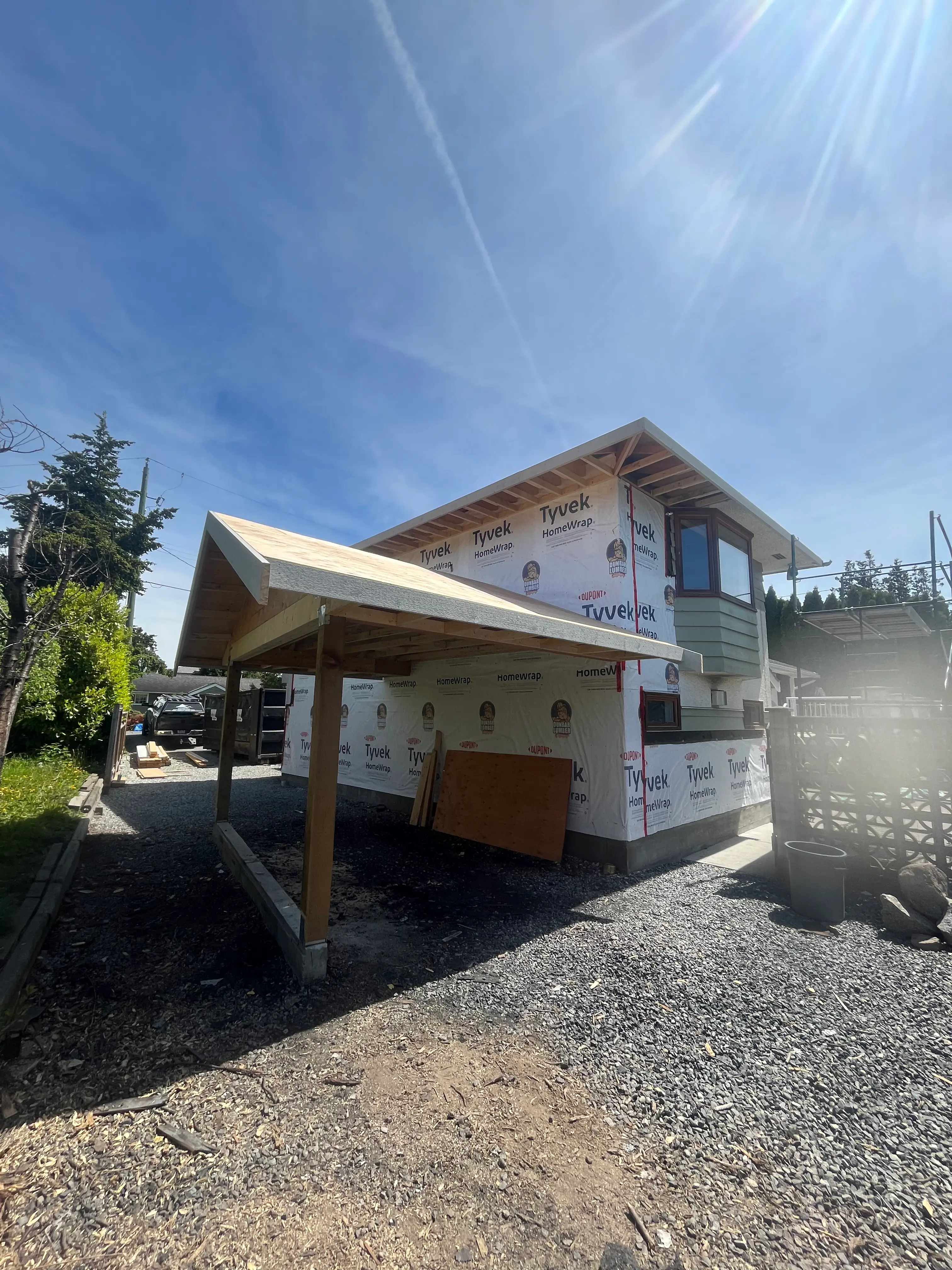 Custom home construction with tyvek wrap and covered outdoor structure