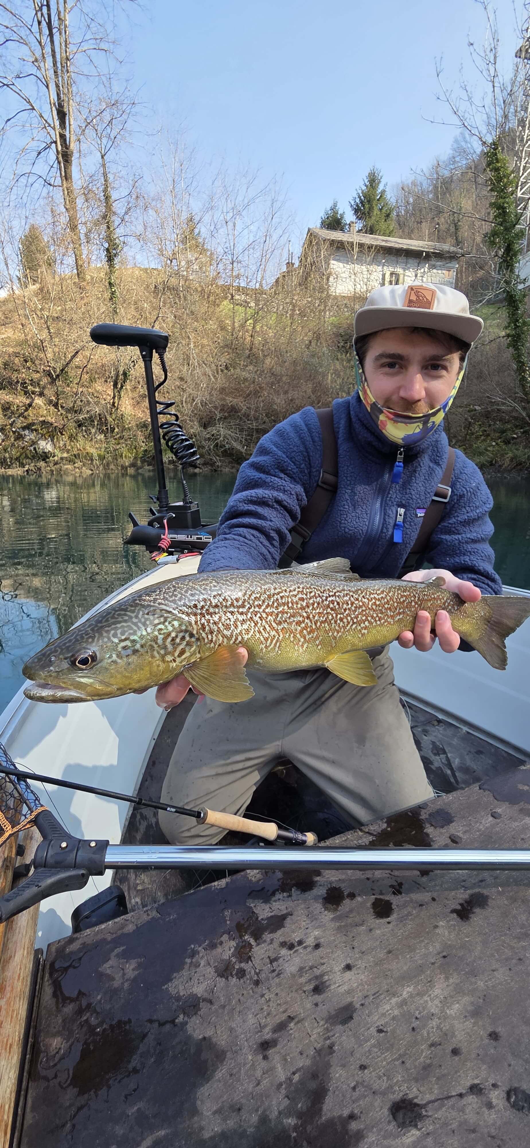 Marble trout fishing in Slovenia on deep alpine lake at the confluence of the Soča, Idrija and Tolminka rivers