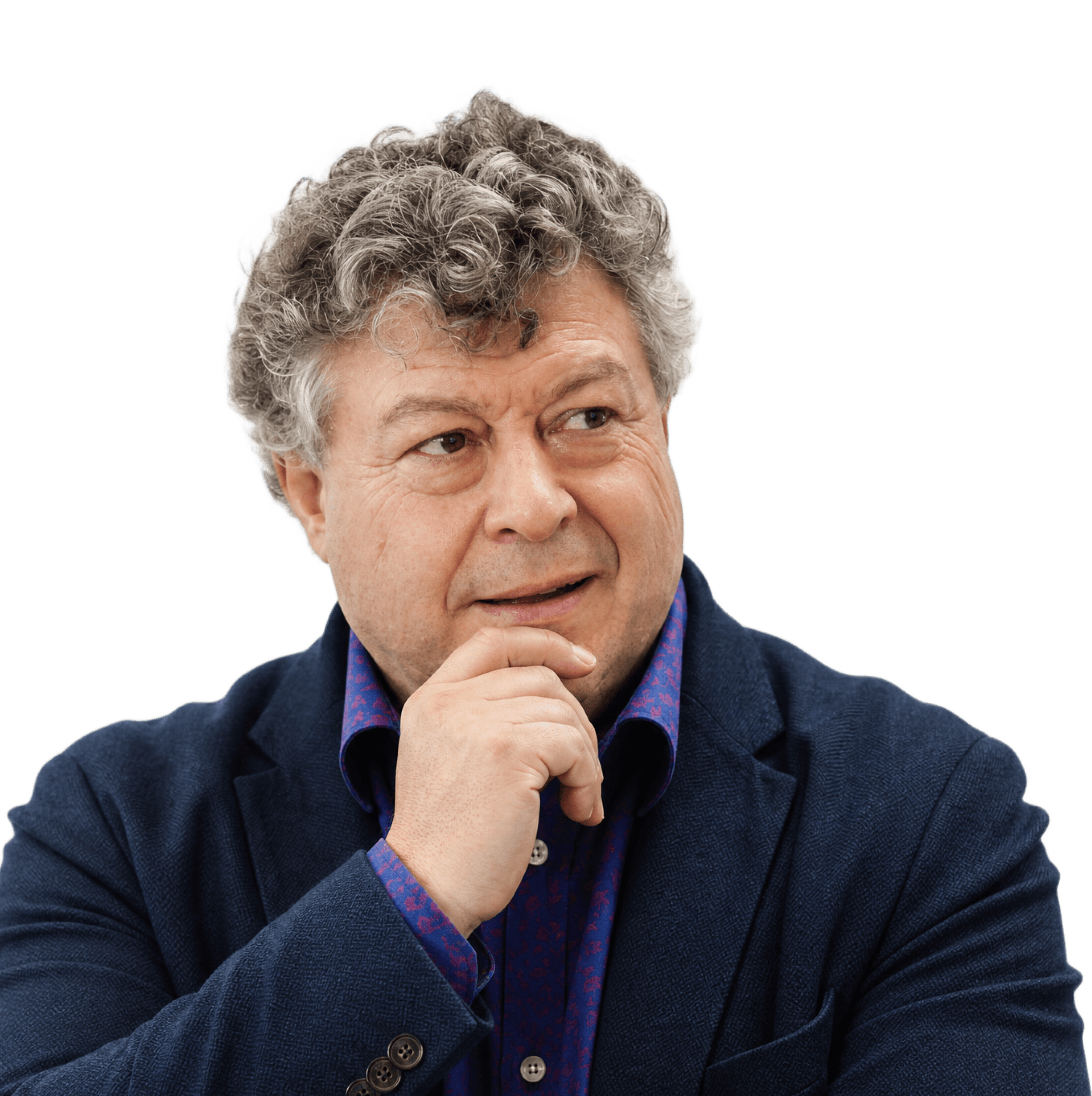 A studio headshot of a man wearing a suit in a thinking pose