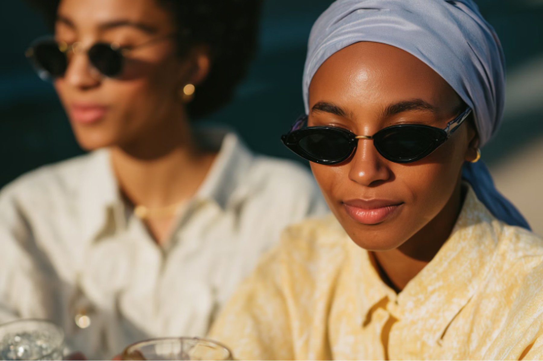 Two girls in sunglasses at a party