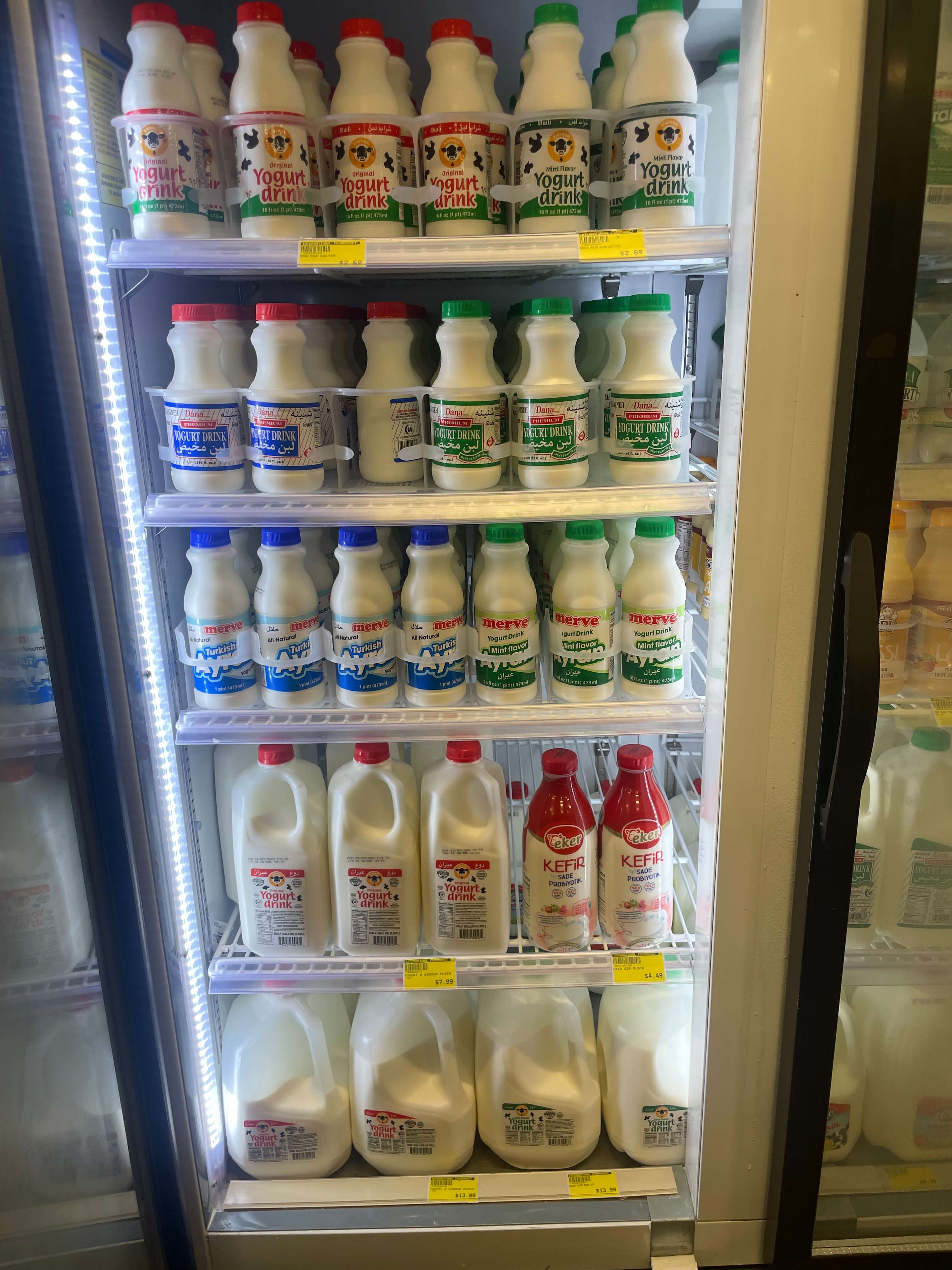 Assortment of laban and ayran drinks in the dairy section at International Food Market Orlando.