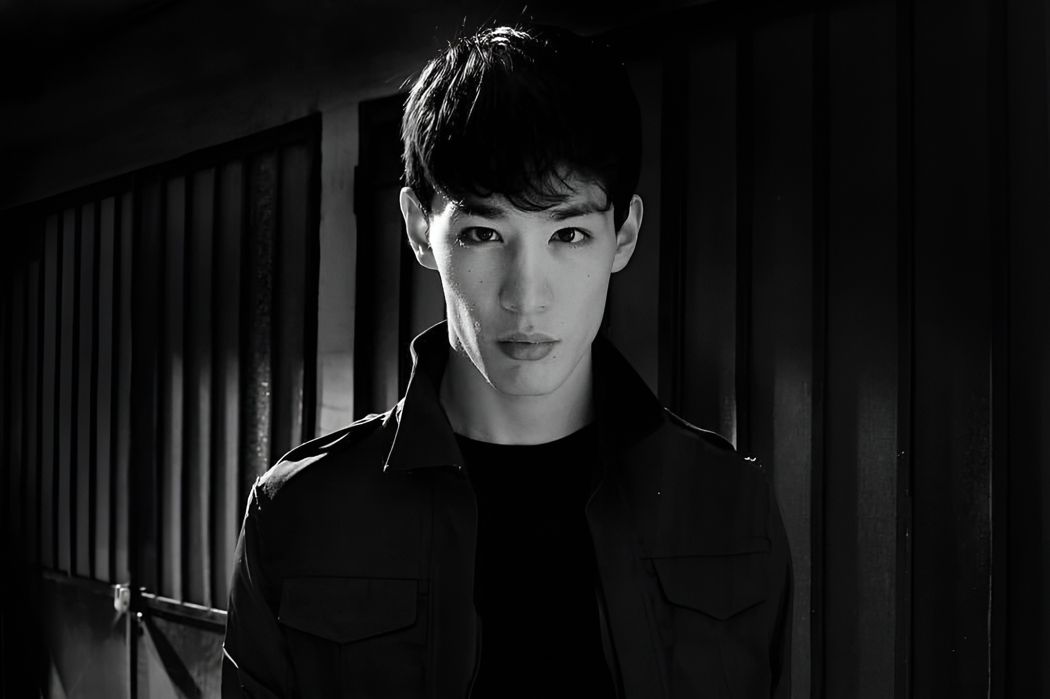 grayscale photo of man in crew neck shirt and eyeglasses