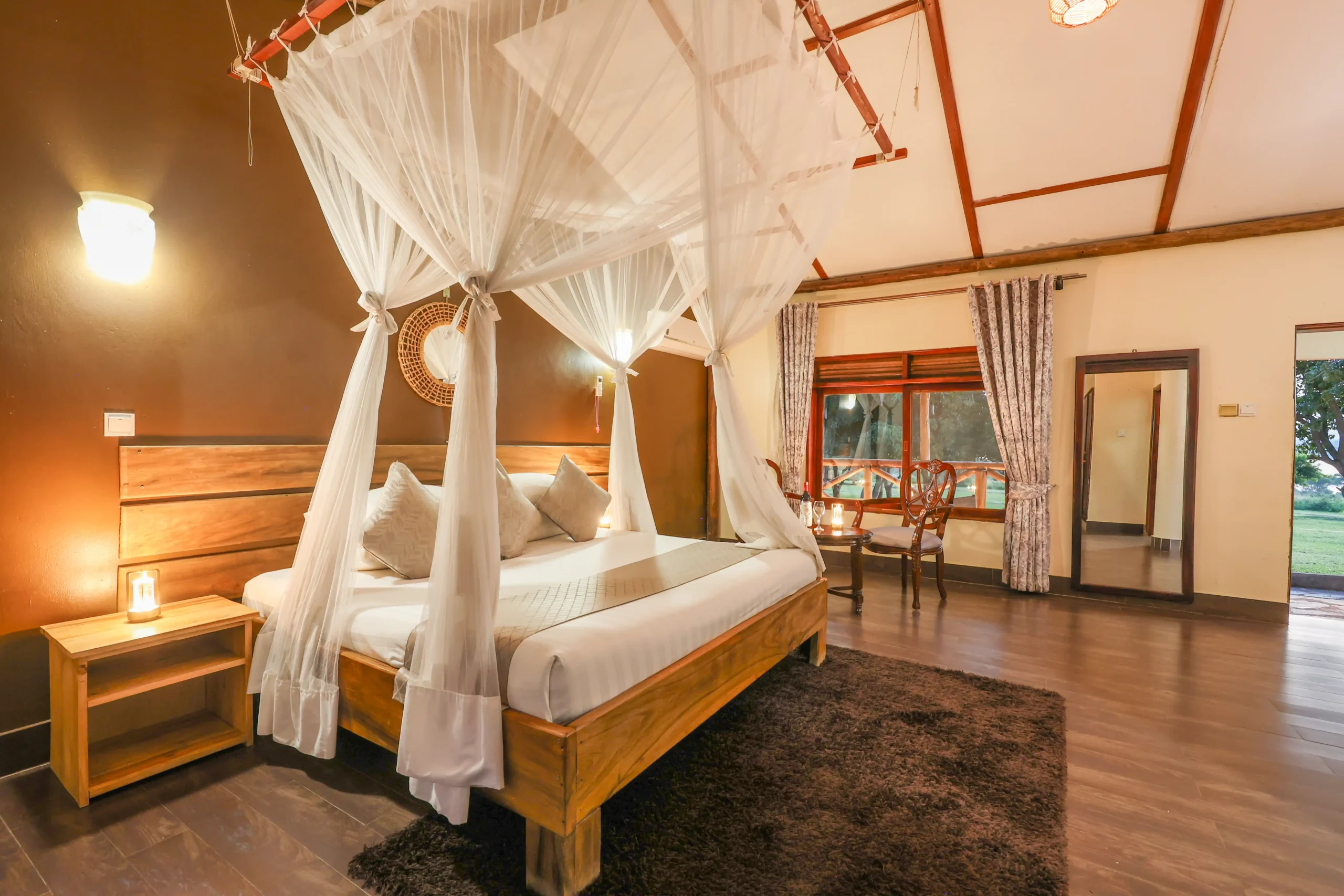 herd of water buffalo walking on grass field during golden hour