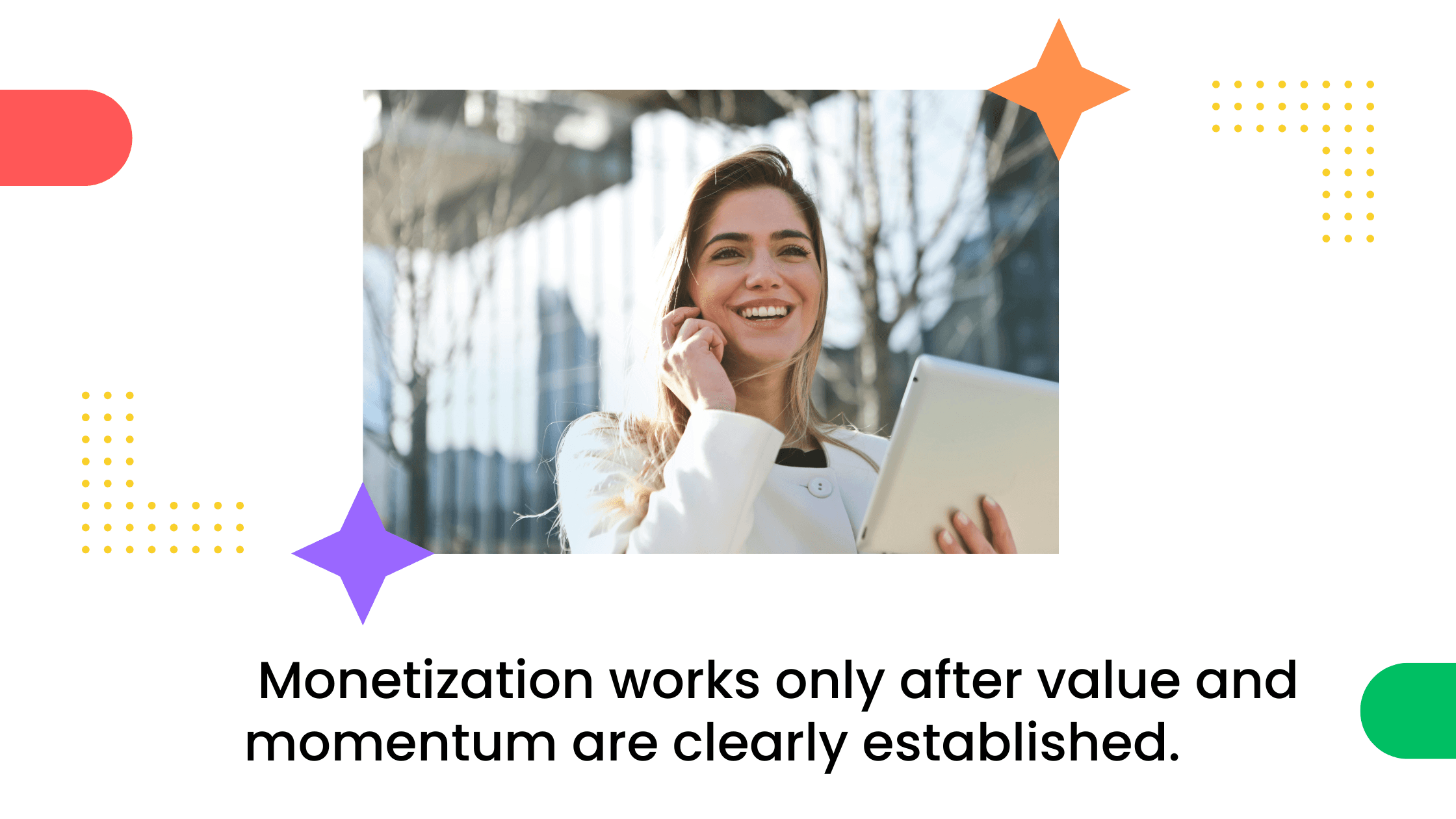 Smiling woman outdoors holding a tablet while talking on her phone.