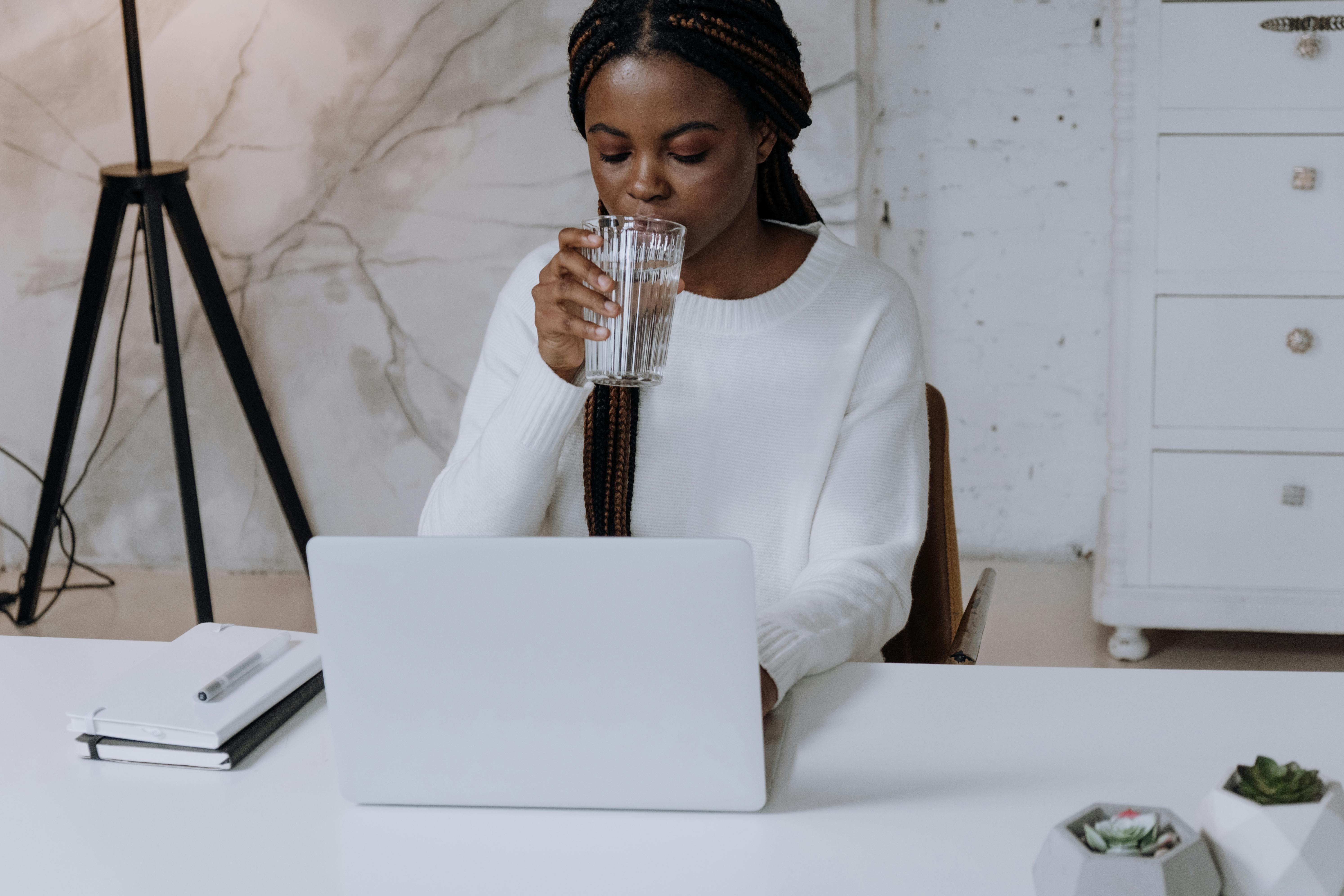 Woman working on laptop turning cold leads into hot prospects