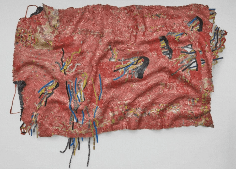 Man lying on a mat with eyes closed in a relaxation or meditation pose beside a burning incense bowl.