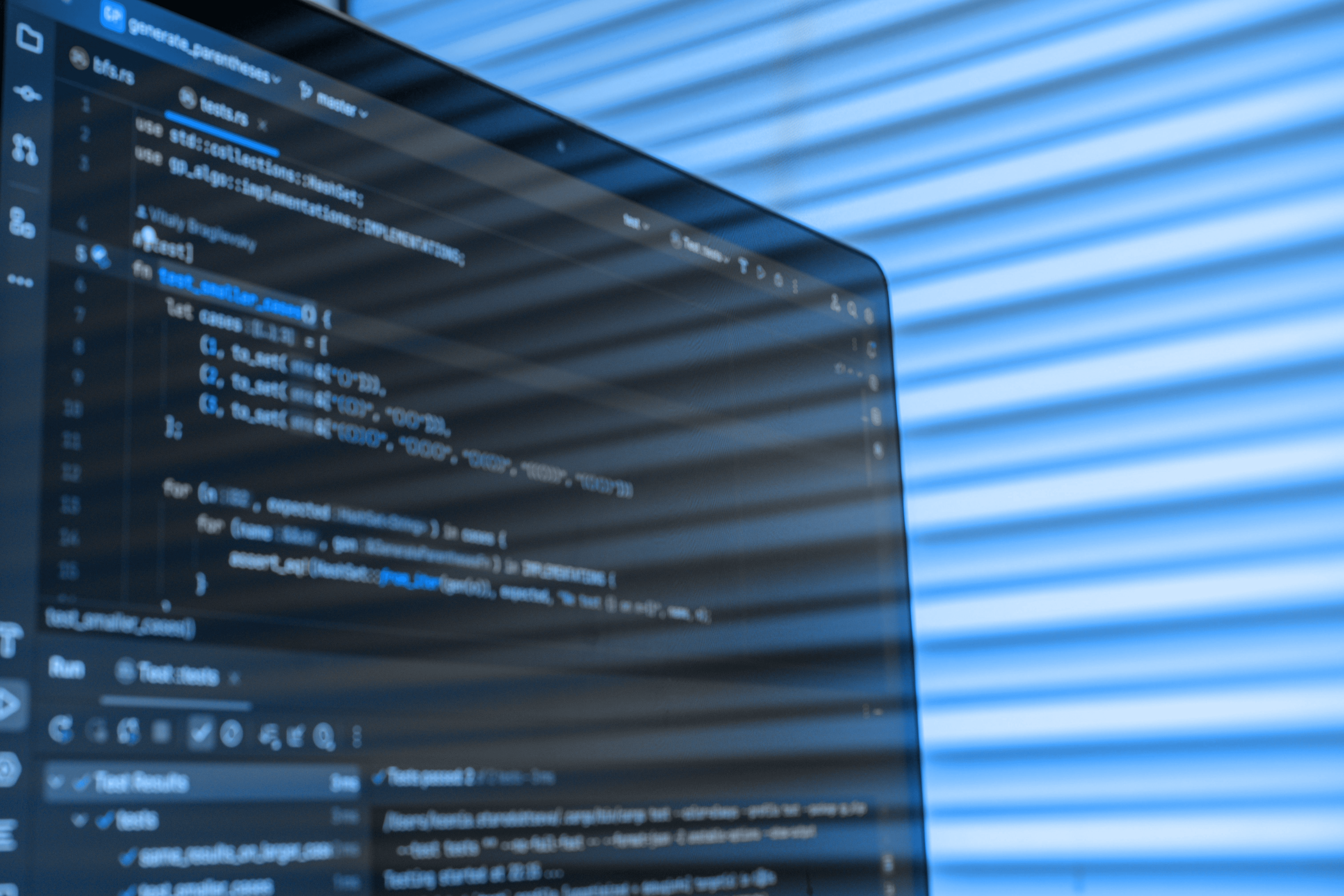 Close-up of a laptop screen displaying code in a developer environment with colorful lighting in the background, representing the technical expertise behind Light + Logic Digital's web development services.