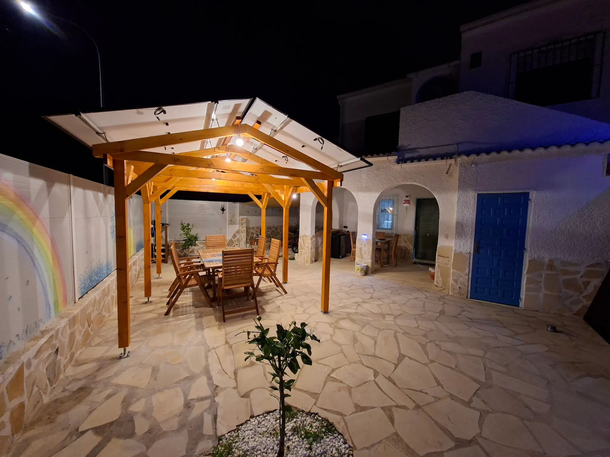Minimalist living space with low modern furniture, large floor-to-ceiling windows, soft natural light, and an open view of a calm outdoor landscape.