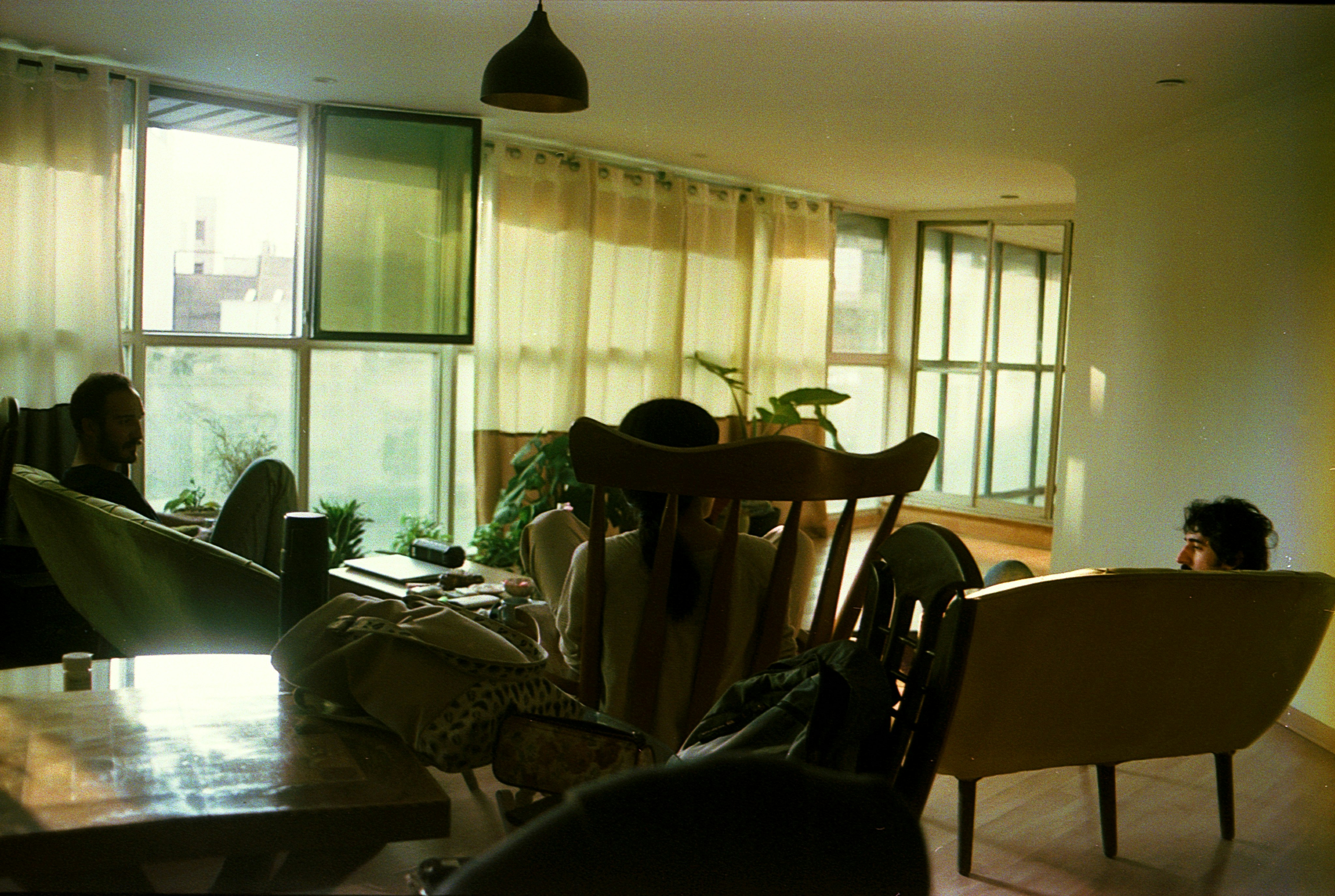 People relaxing in a light and airy living room.