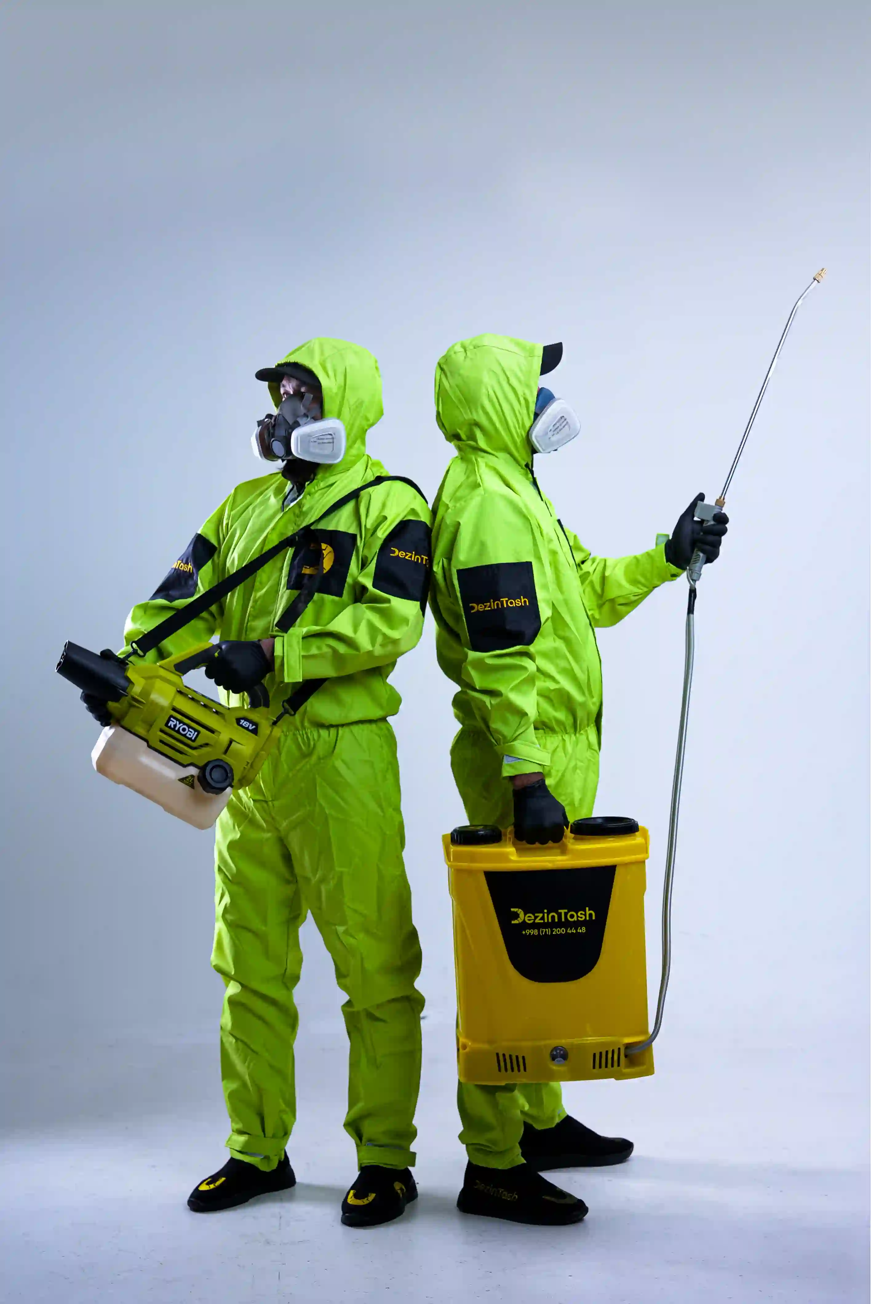 Two men discuss a project while standing at a laptop in an office.