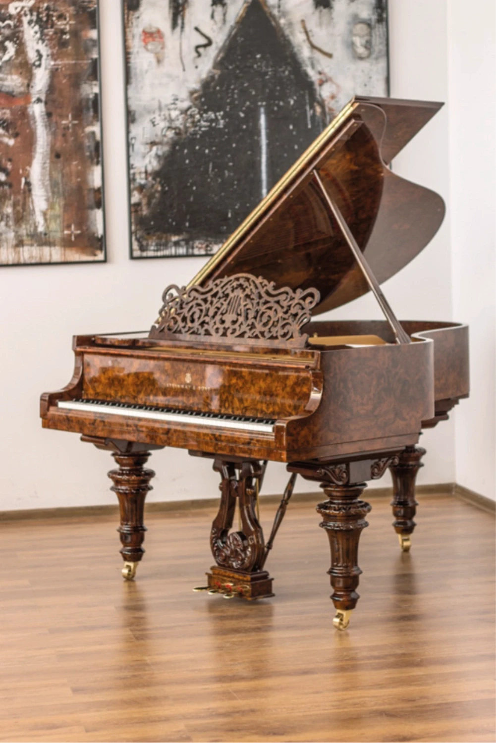 Exquisitely restored antique grand piano with intricate wood carvings, expertly renovated by Meyer Pianos.