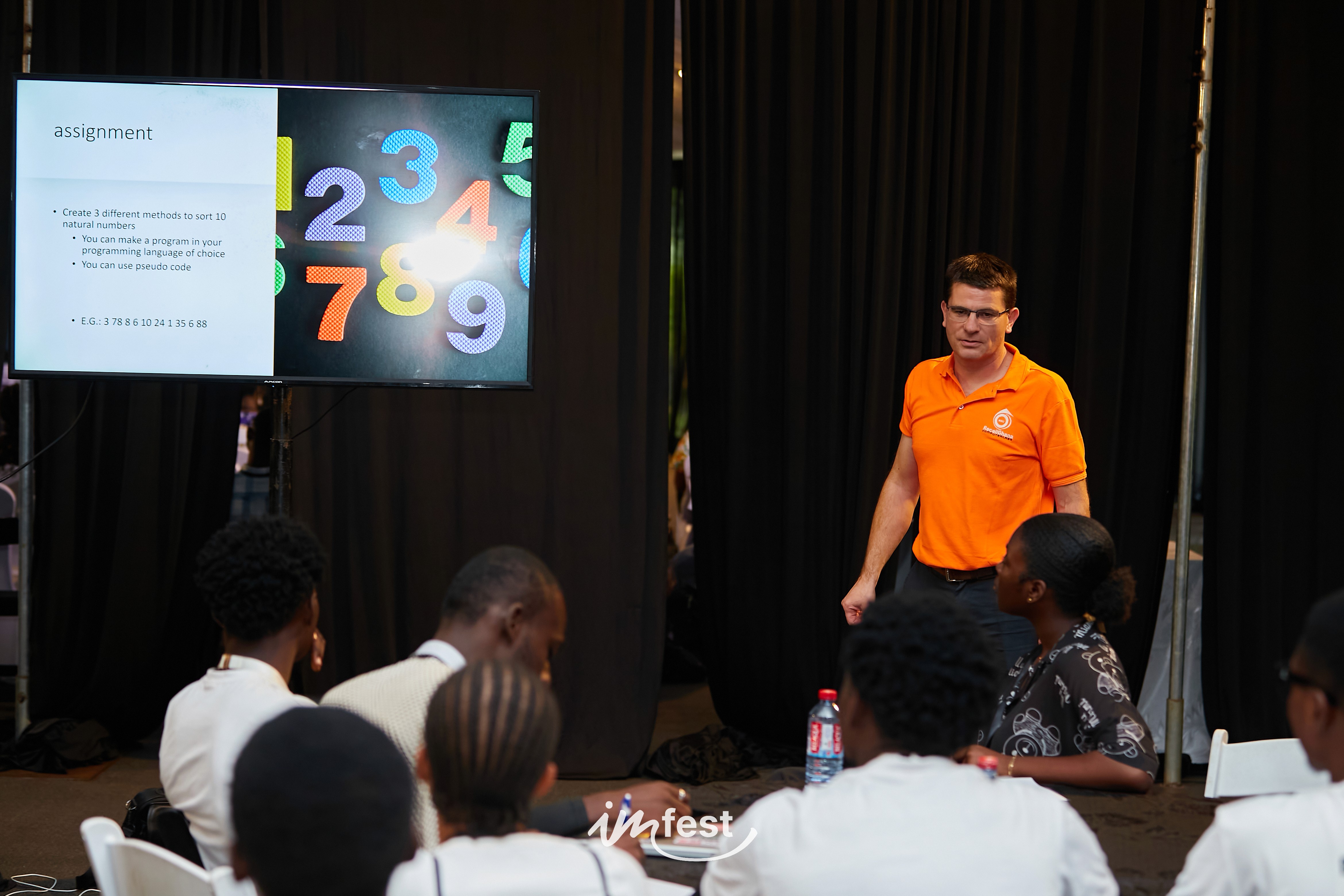 An orange cube-shaped side table is shown.
