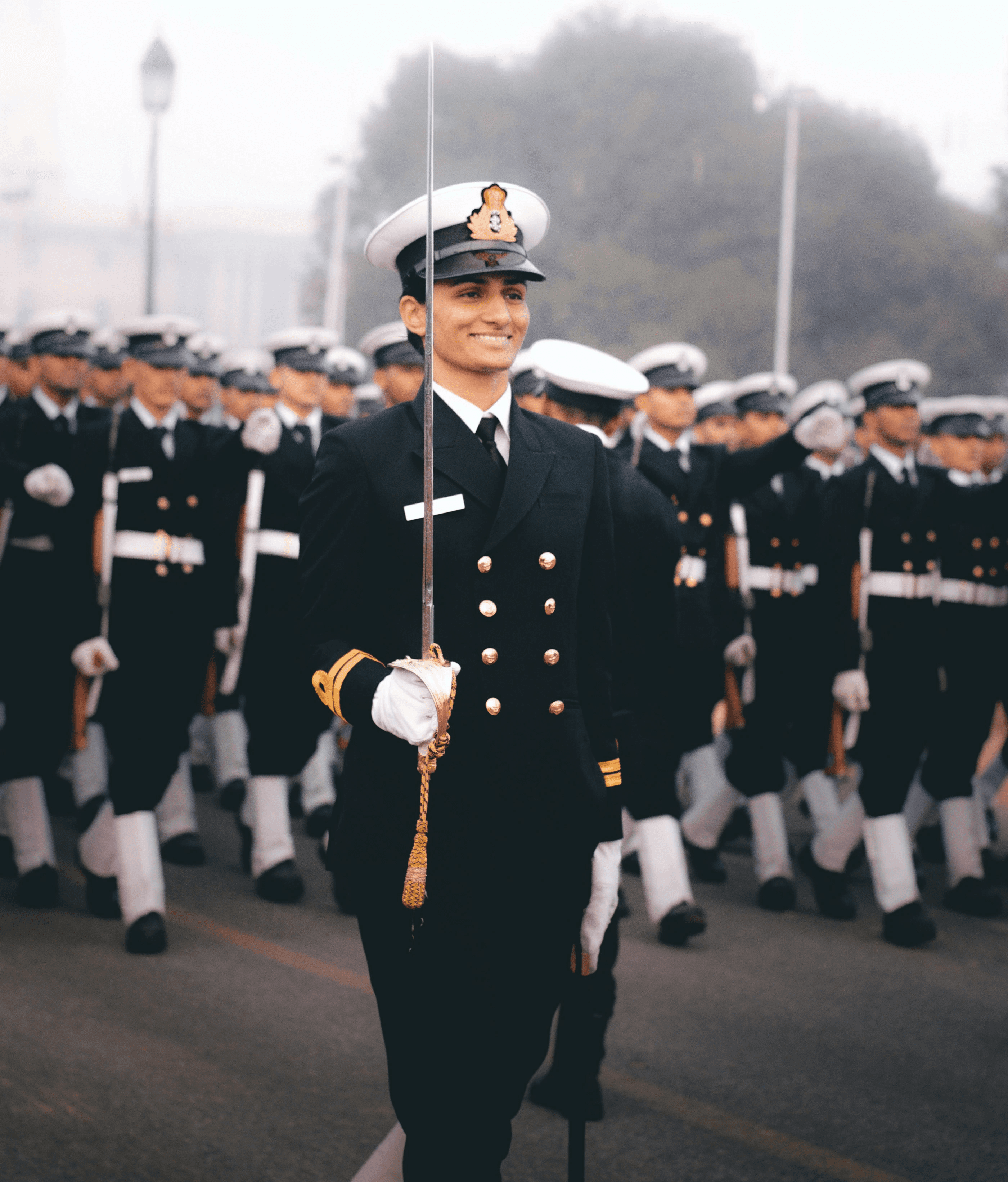 a man in a uniform with a group of people in the back