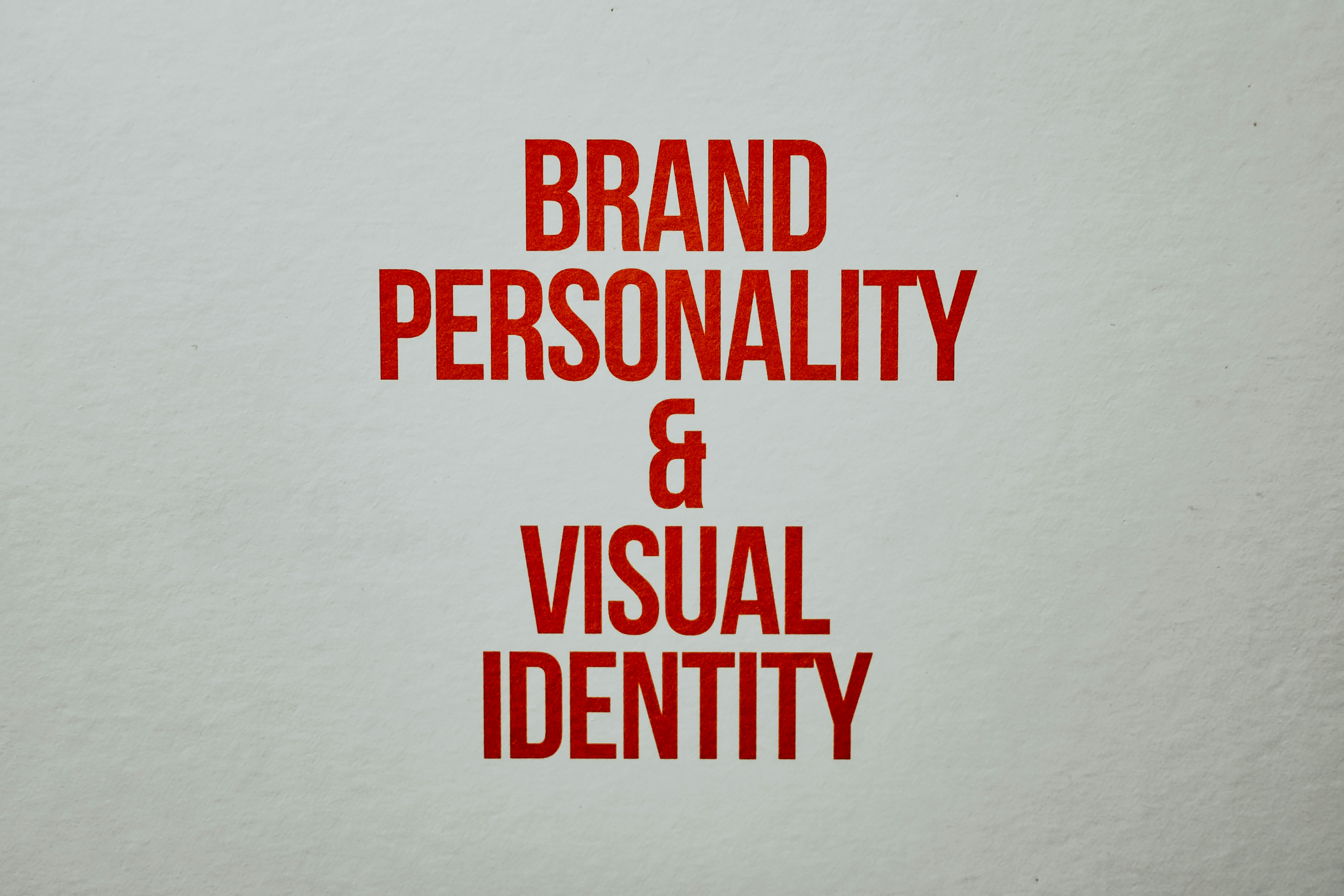Text in bold red reads: "BRAND PERSONALITY & VISUAL IDENTITY" on a plain background.